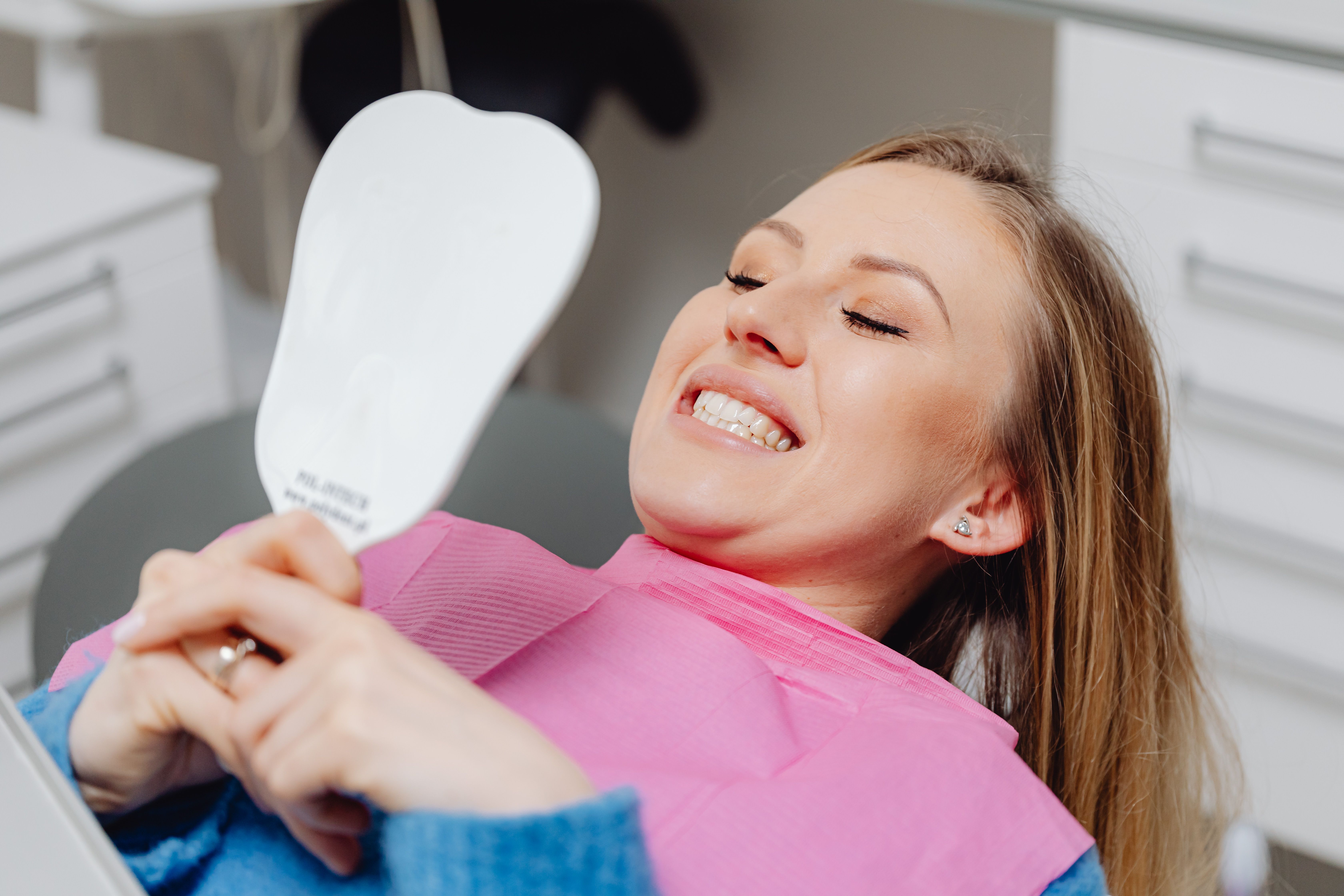 Flat lay of cosmetic dentistry tools and a veneer model