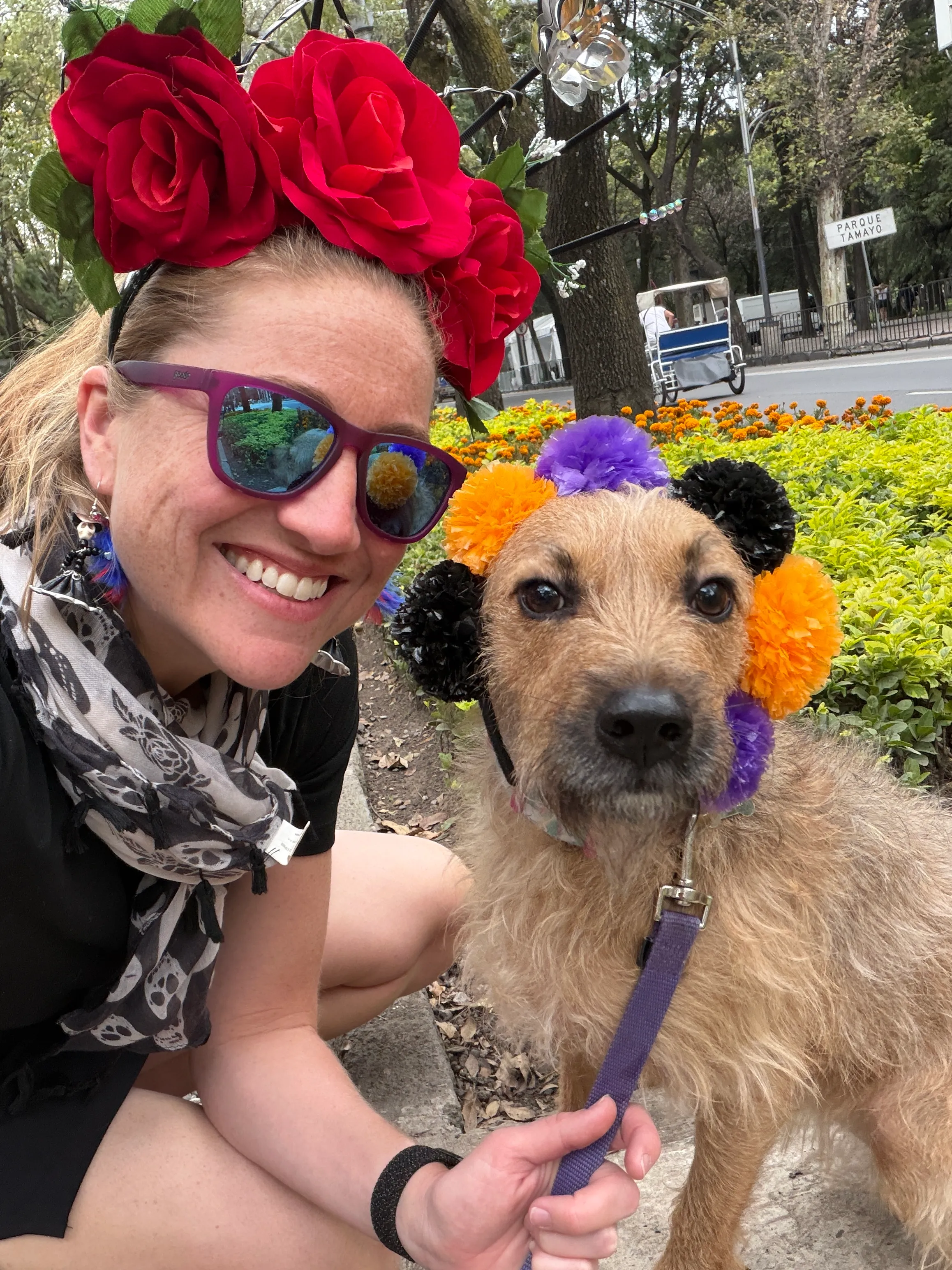 Robyn wearing a floral headband beside her dog at an outdoor park