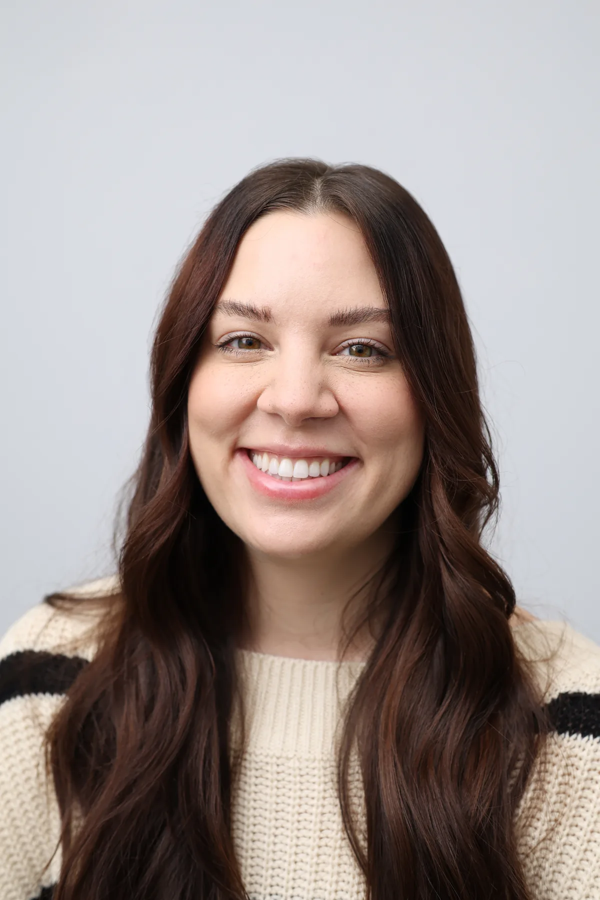 Livewell Dental patient smiling six months after her porcelain veneer treatment