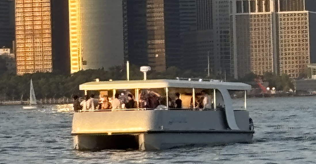 Skyline yacht at sunset with the Manhattan skyline
