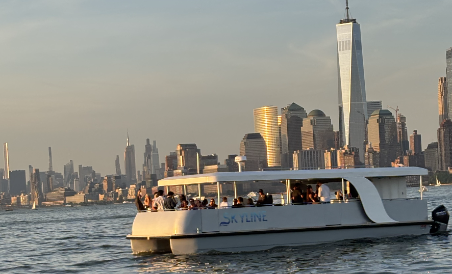 Skyline yacht at sunset near One World Trade Center, NYC