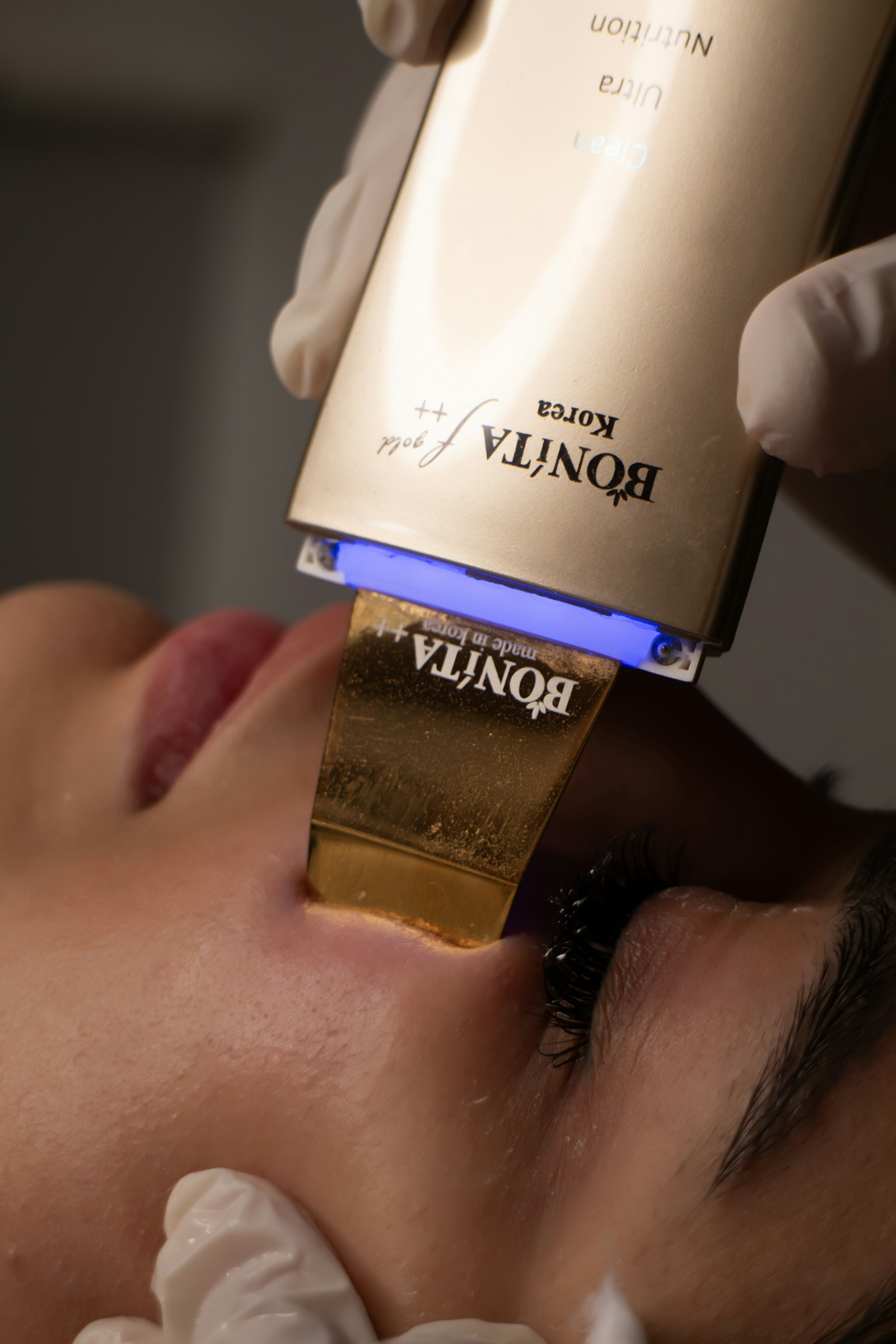Professional aesthetic skincare device treatment — exosome facial therapy at a luxury clinic