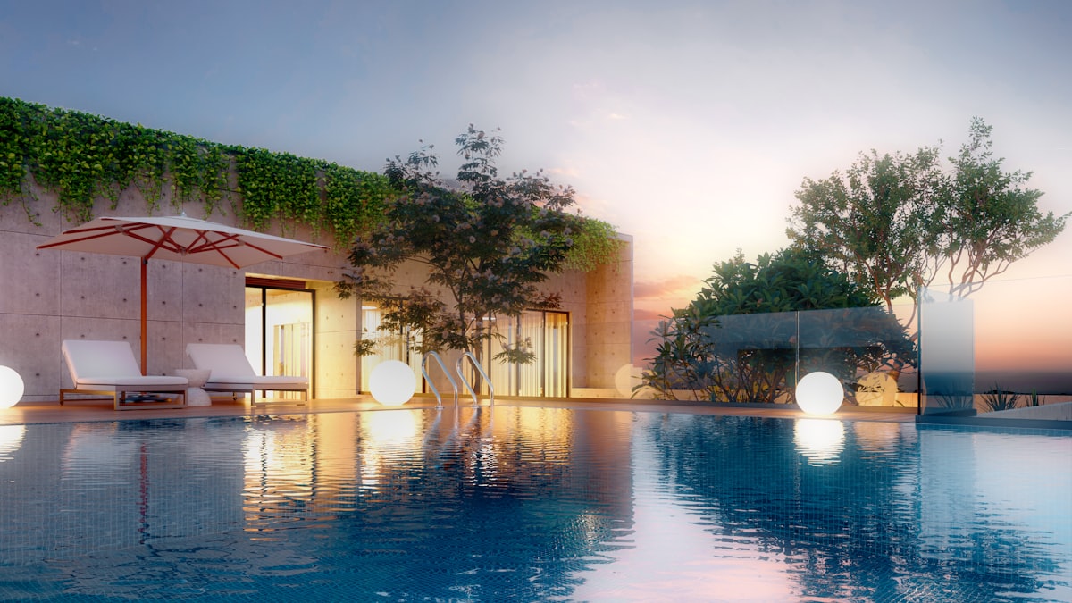 Rooftop luxury pool at sunset overlooking the city skyline