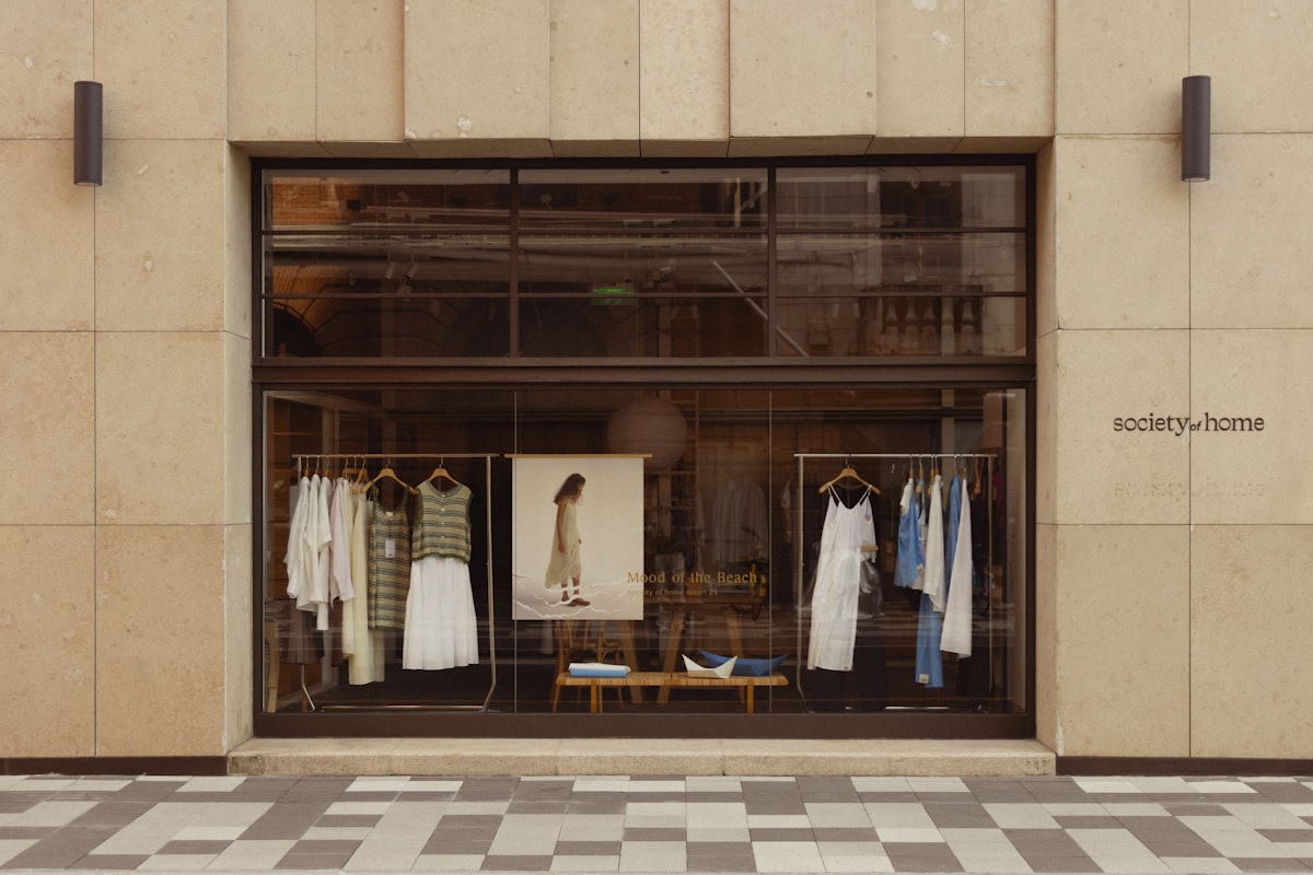 Fashion boutique store window display with designer clothing and mannequins