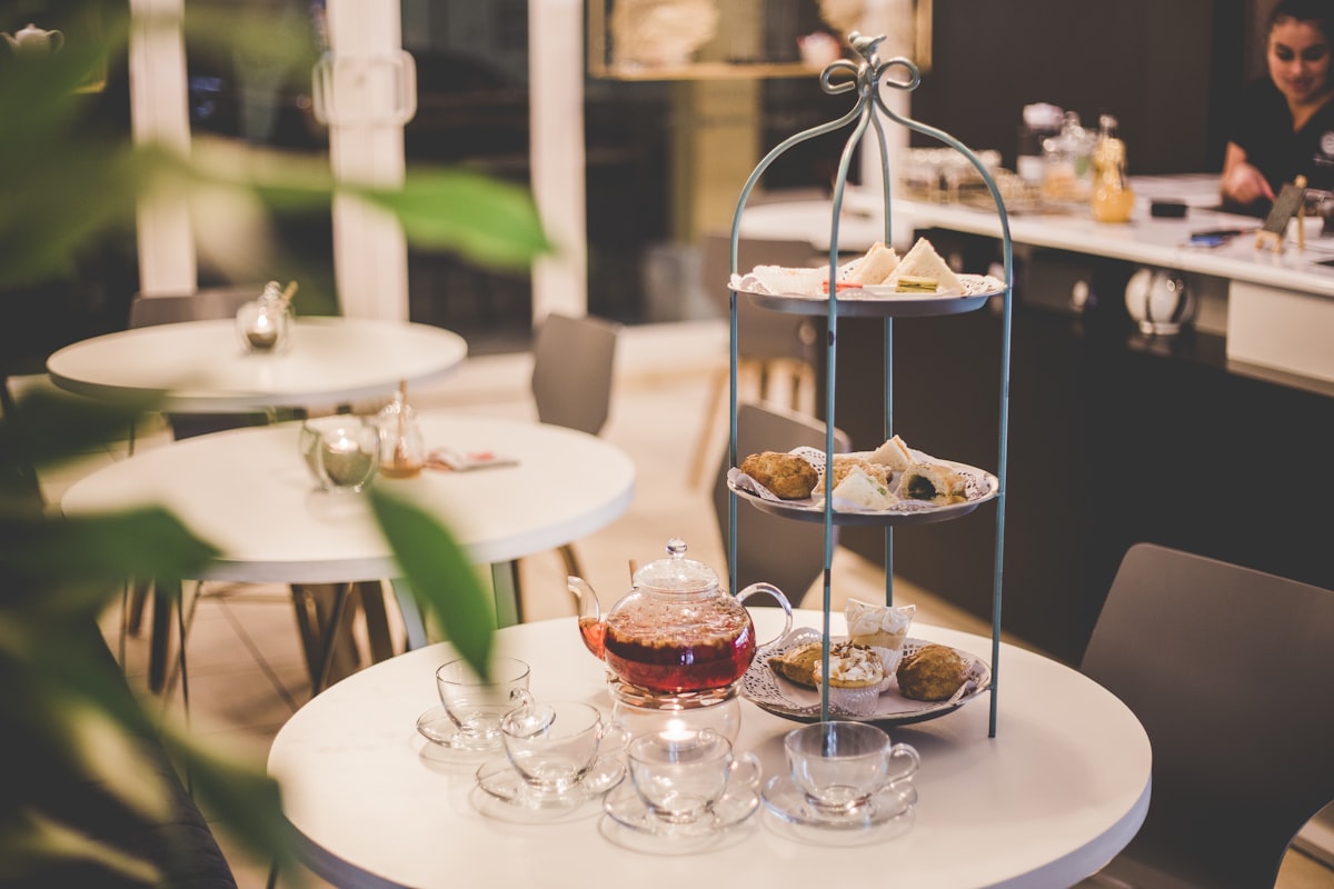 Afternoon tea set with tiered rack of pastries on a round table