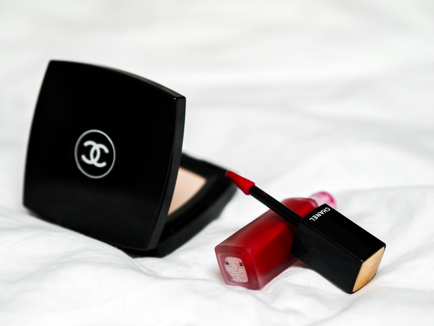 Red luxury lipstick beside black box — Charlotte Tilbury's iconic pillarbox red branding