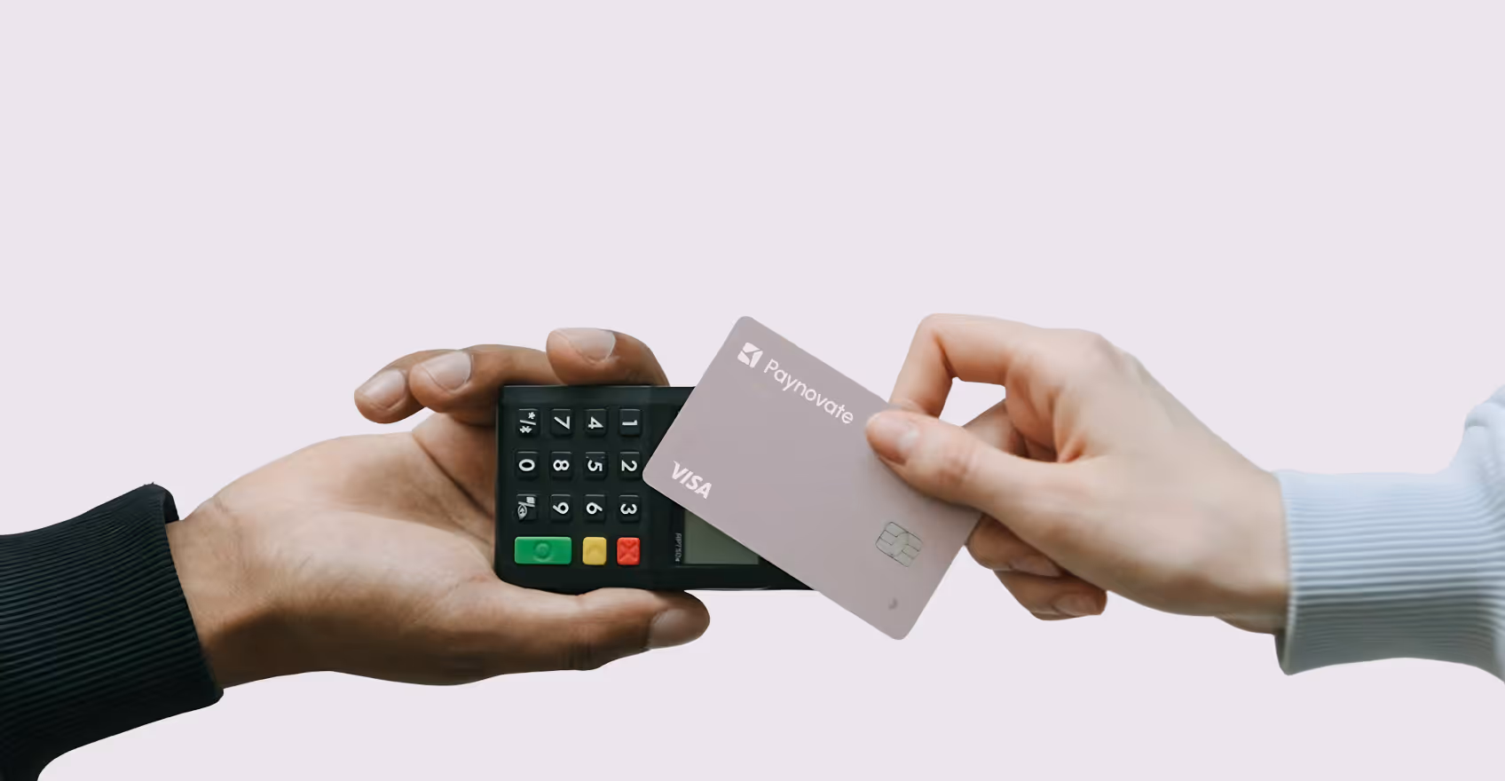 Hand holding a payment terminal while another hand holds a Mastercard credit card near it for payment.