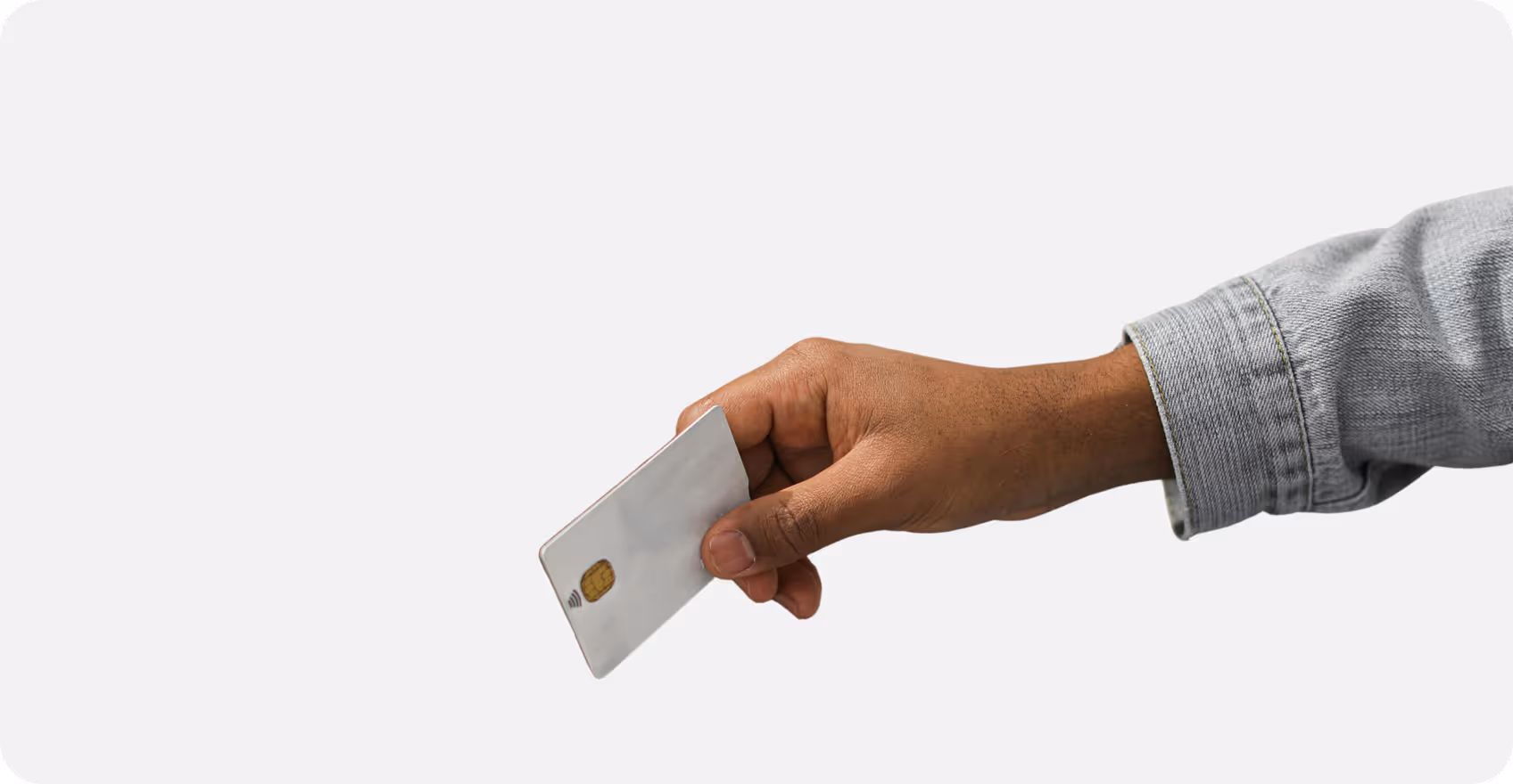 Hand holding a white smart card with a visible chip against a plain white background.