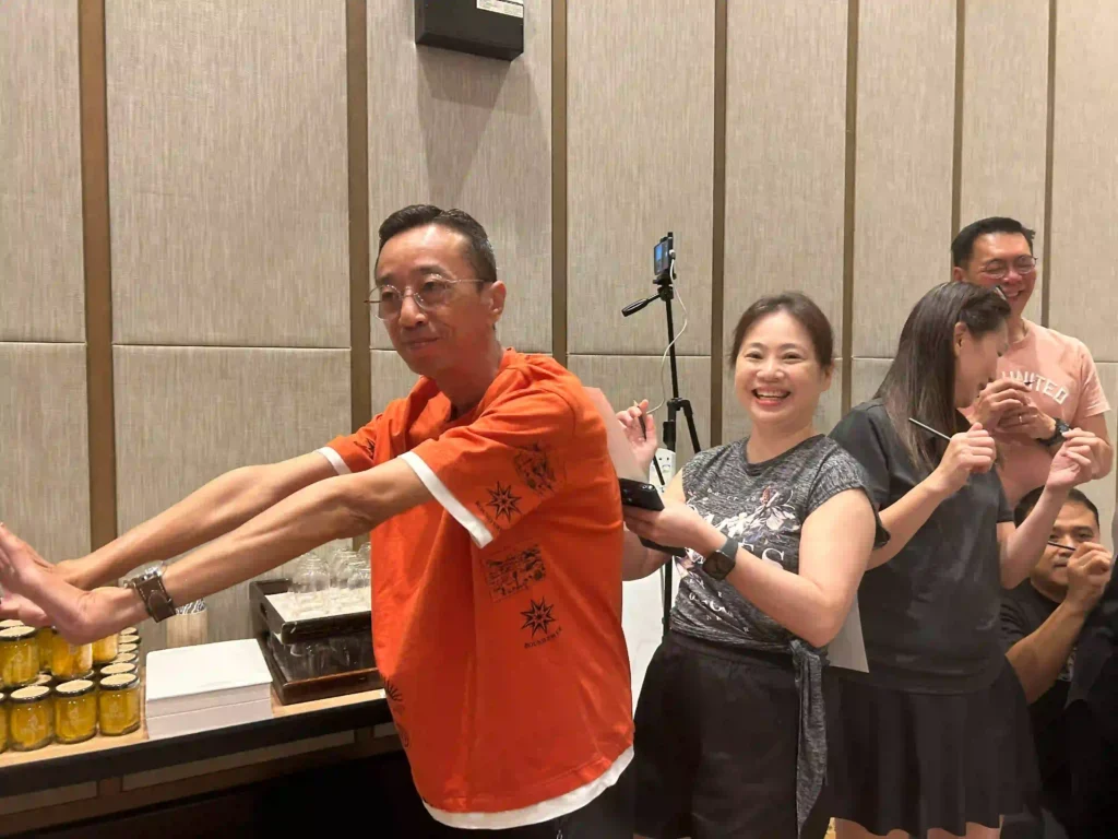 A group of people from Vision Building are laughing and having fun during an interactive team-building game. The photo highlights a moment of pure entertainment, which can fail to create lasting change on its own.