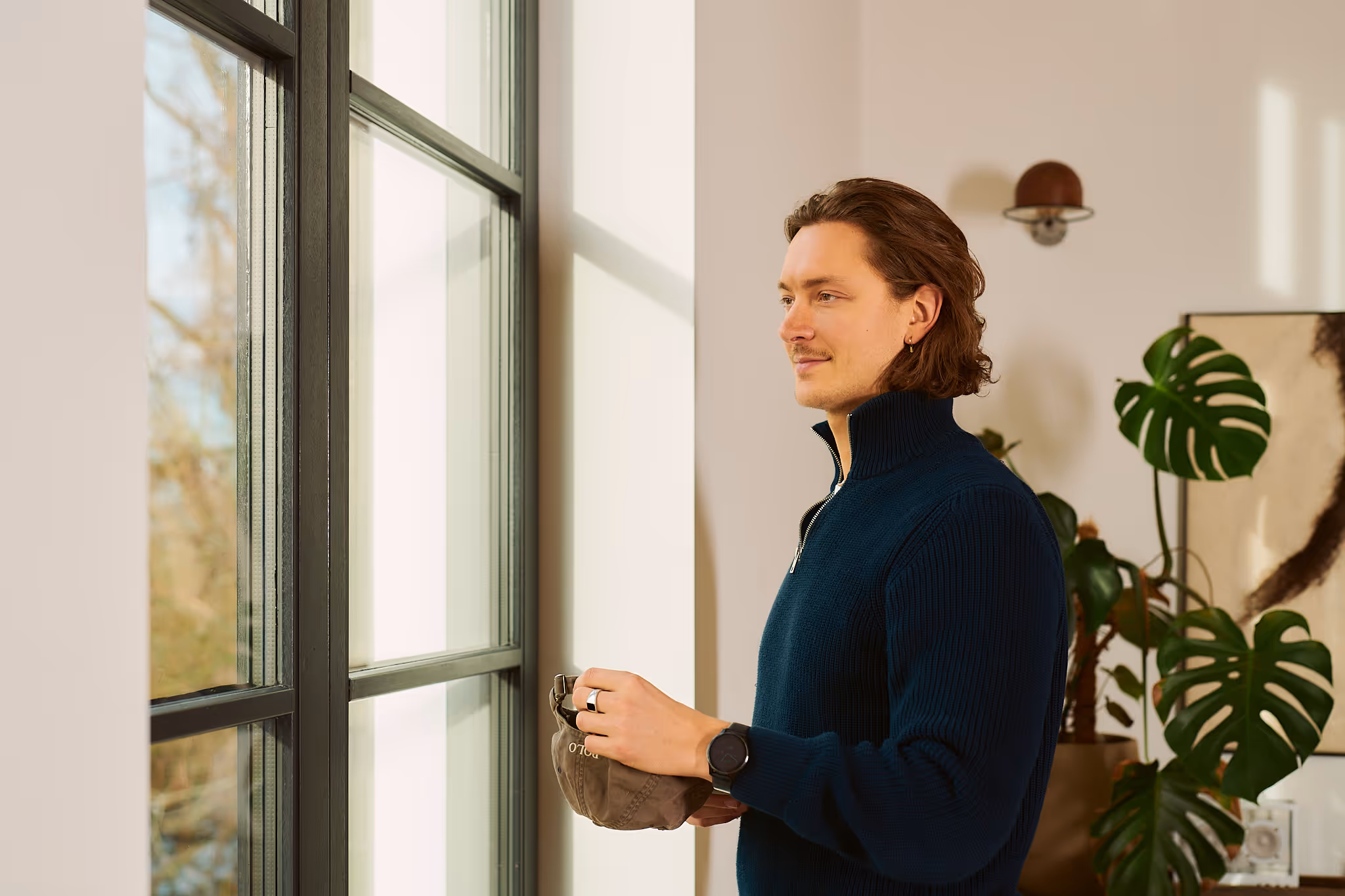 a man standing in front of a window