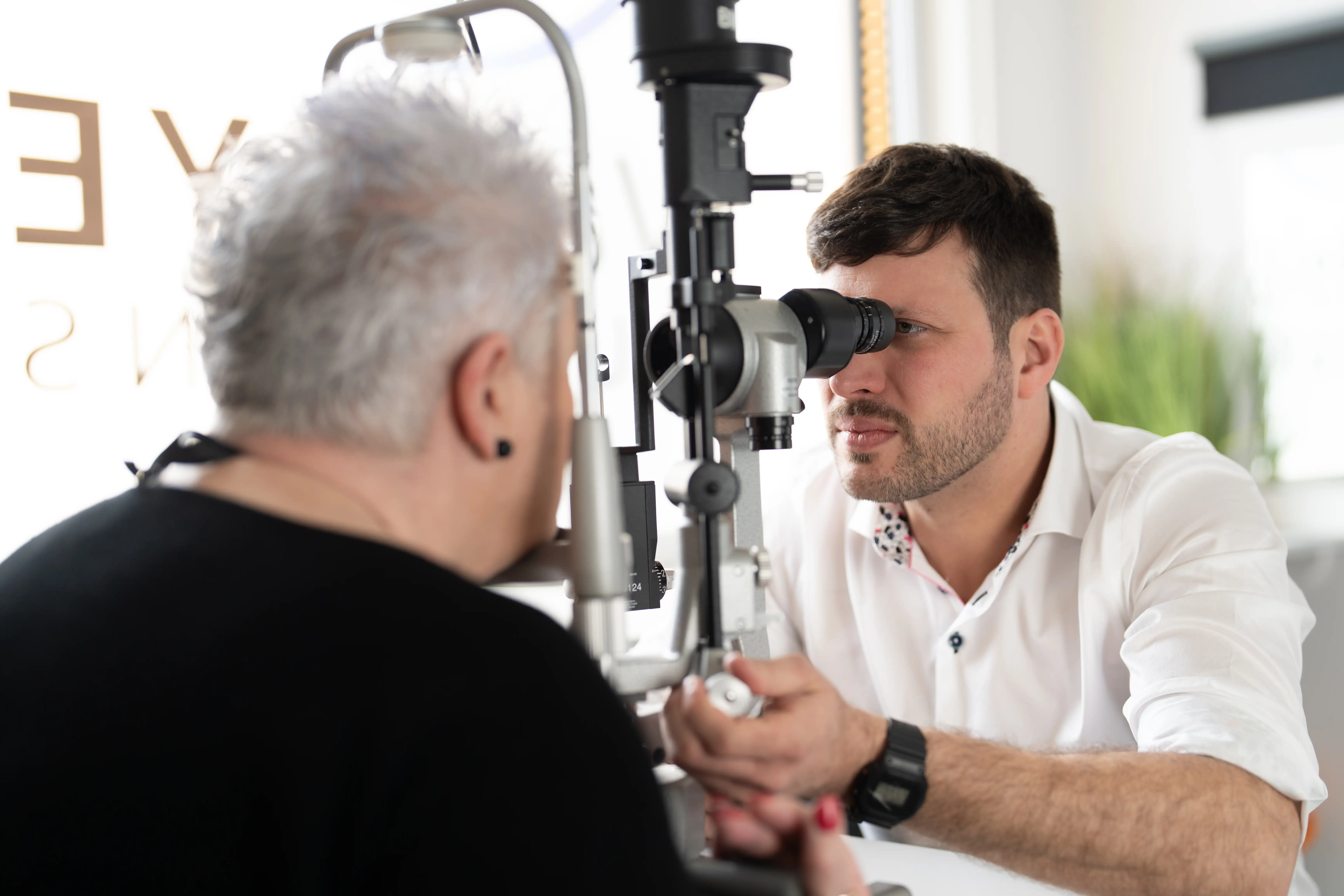 Mr Thomas Betts, consultant ophthalmologist at Vale Eye Surgeons, conducting an eye examination on a patient