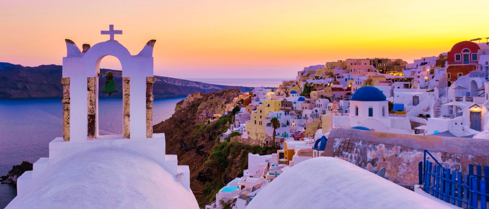 Whitewashed archways of a Cycladic village at sunset