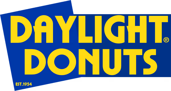 Daylight Donuts logo with bold yellow text on a blue background and establishment year 1954.