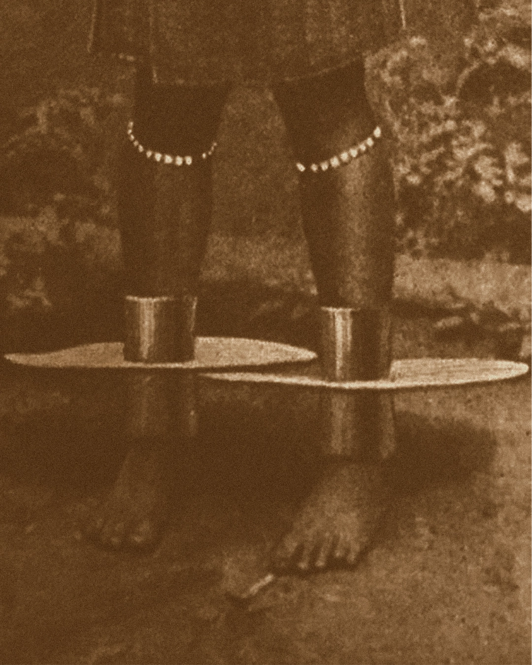 Woman standing wearing Igbo brass anklets — reference for Adala by ỌNWỤ Design