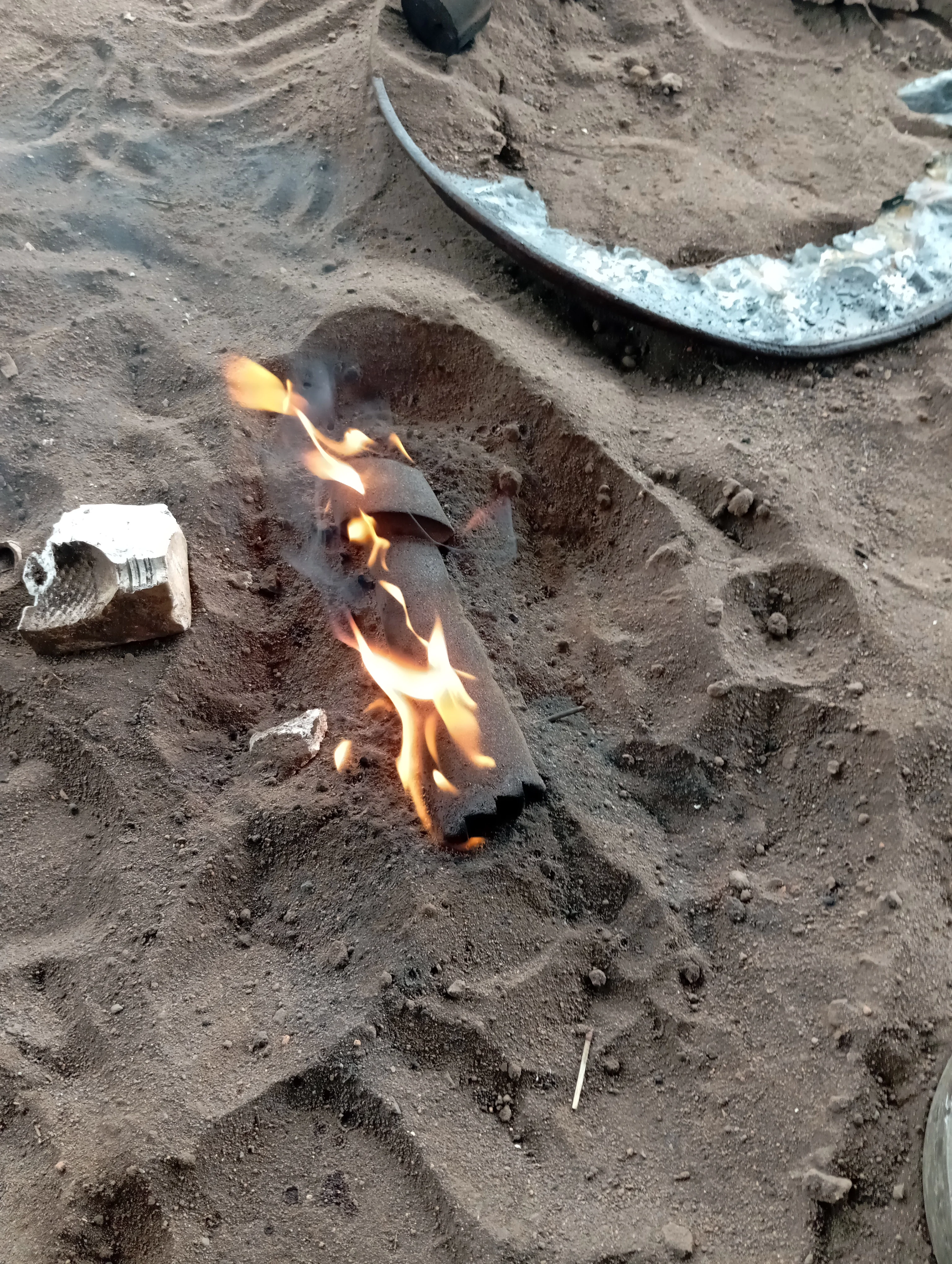 Molten brass being poured into sand mould during Adala vase production