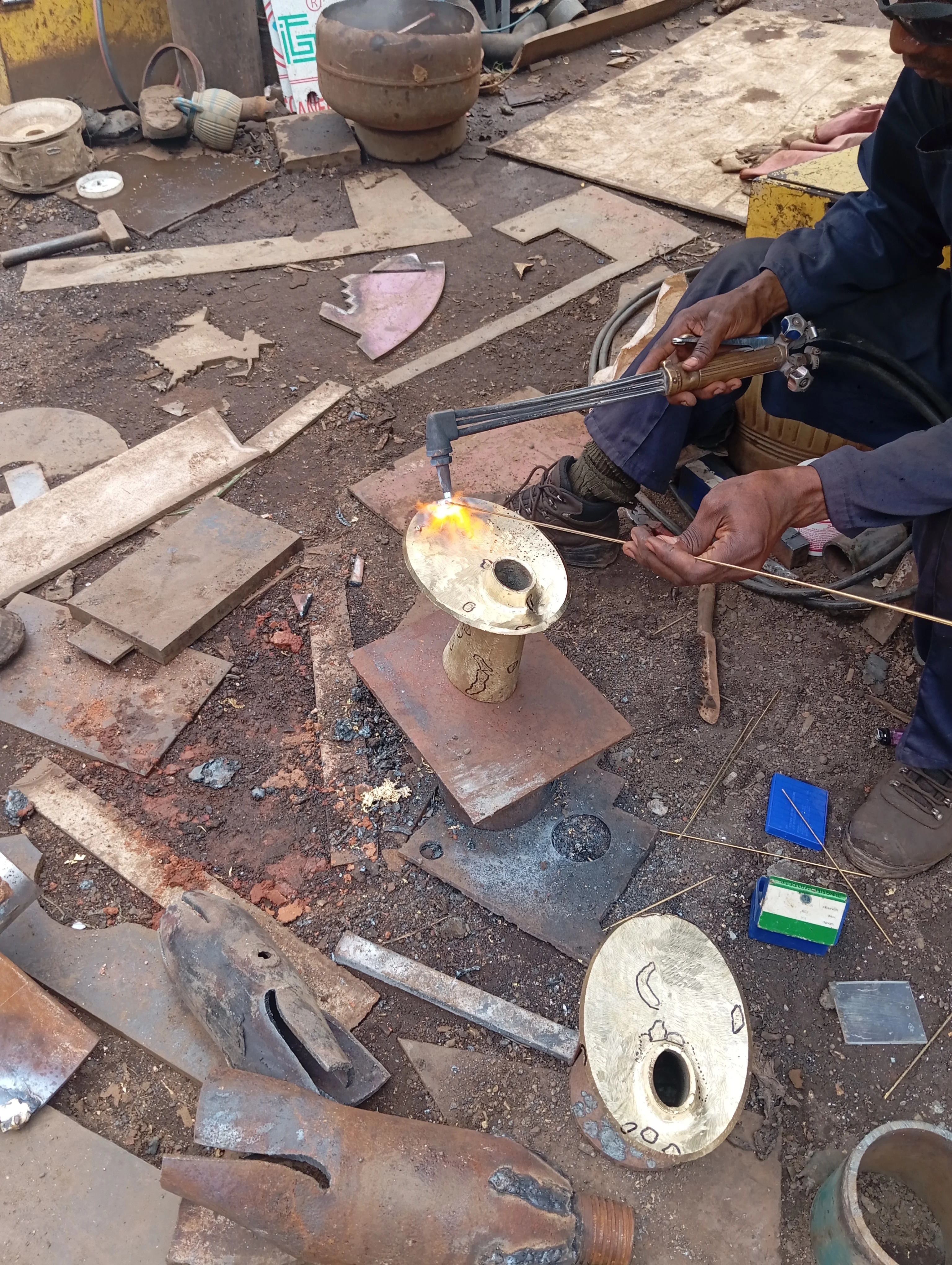 Adala brass vase sand casting — molten metal being poured into sand mould at ISMAC Foundry, Lagos