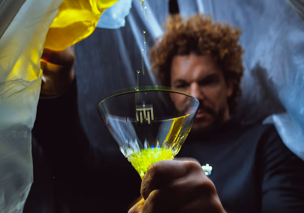 Mario Hofferer pouring a neon green drink.