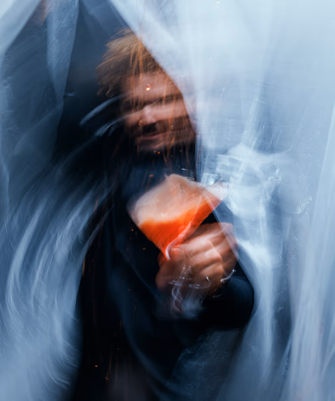 Blurry image of Mario Hofferer pouring a cocktail.