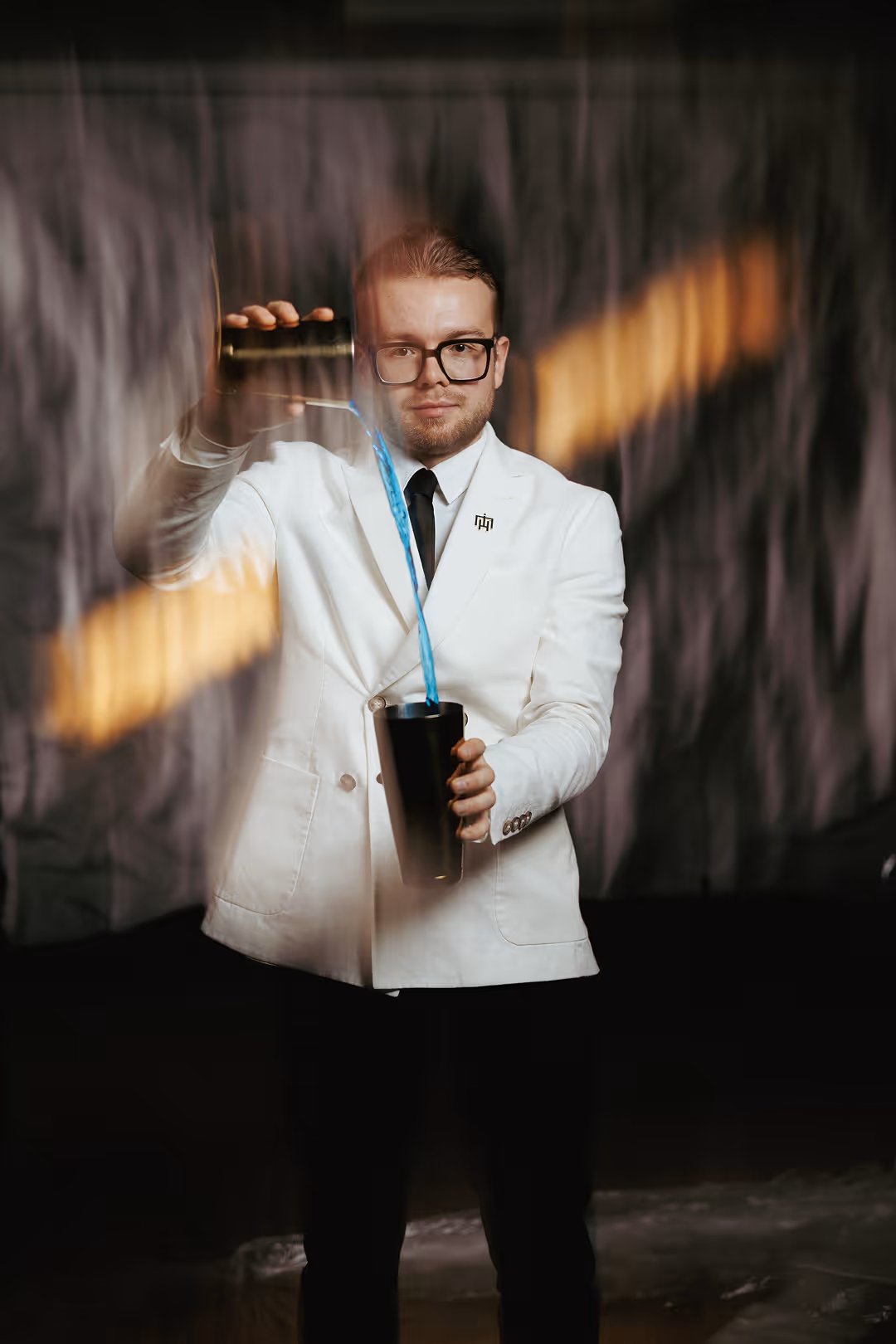 Portrait of Dominik Wenigwieser in a white suit