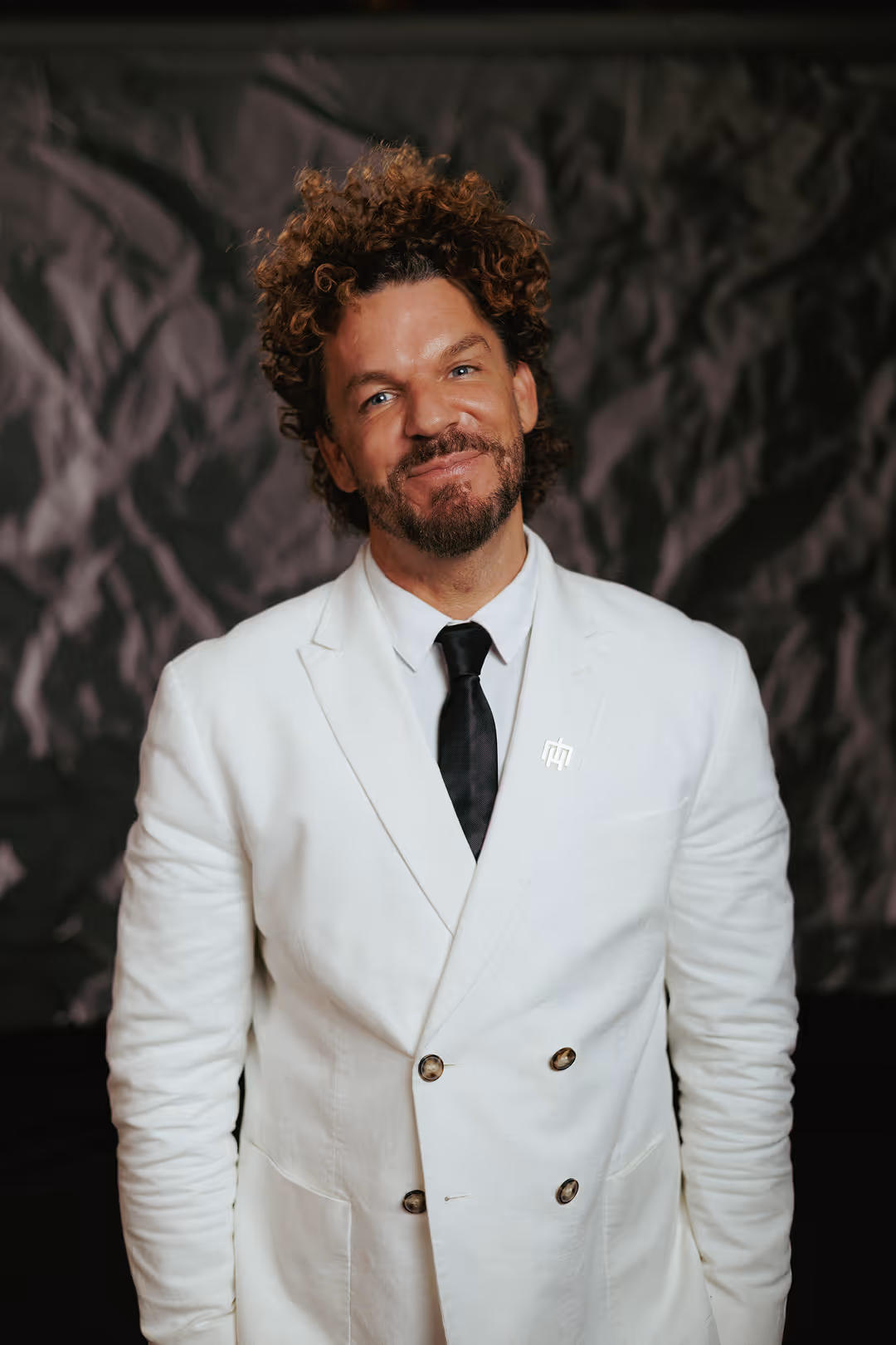 Portrait of Mario Hofferer in a white suit