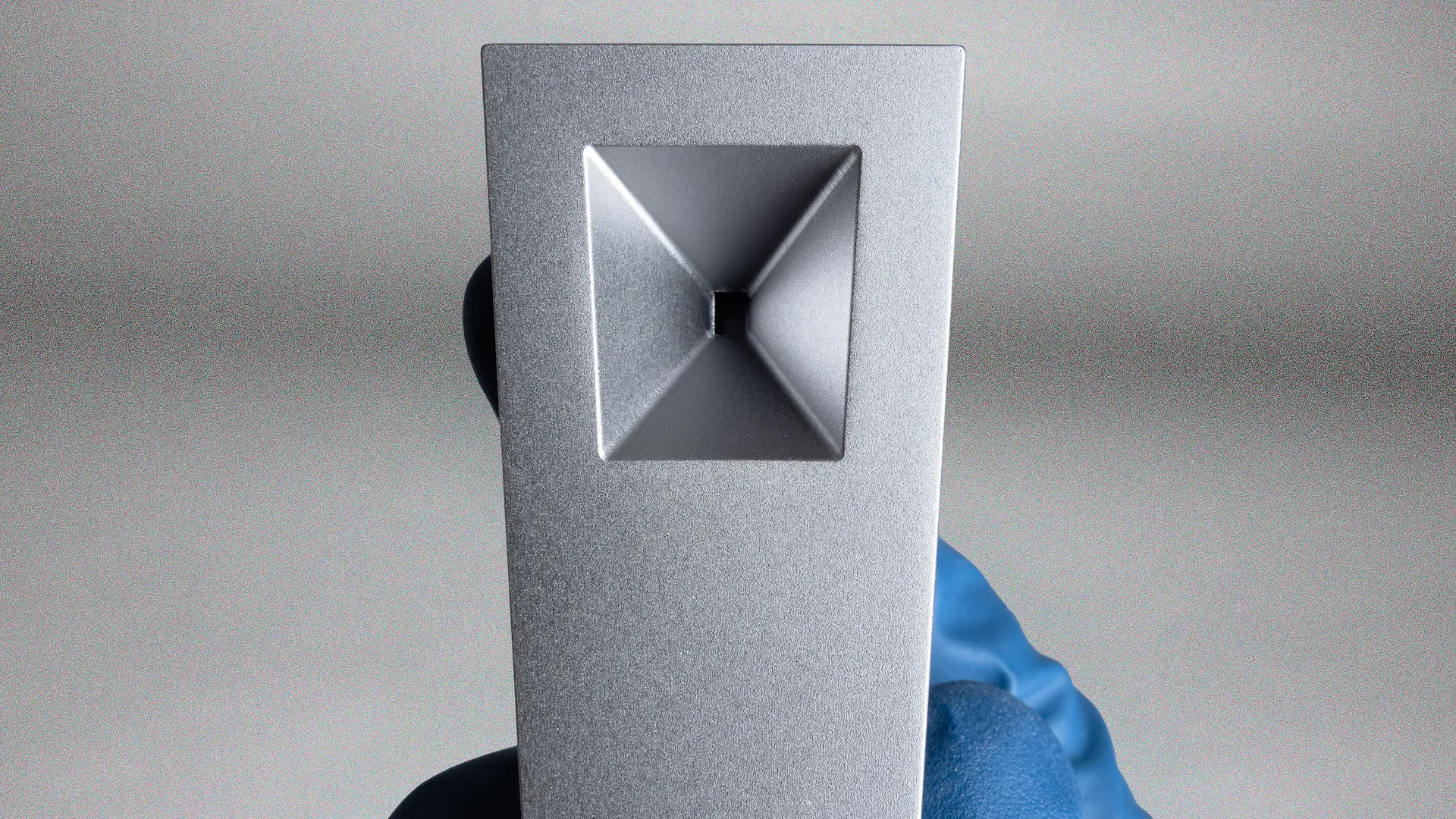 A closeup of the square bowl of a Tempest pipe in Mercury (silver anodized finish)