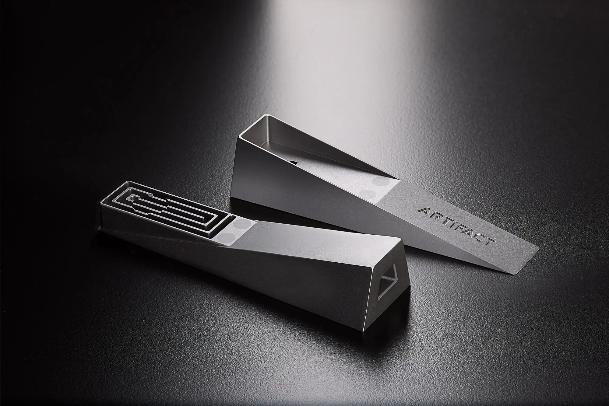 A silver Mercury modern designer Tempest smoking pipe broken apart in a studio with dramatic lighting