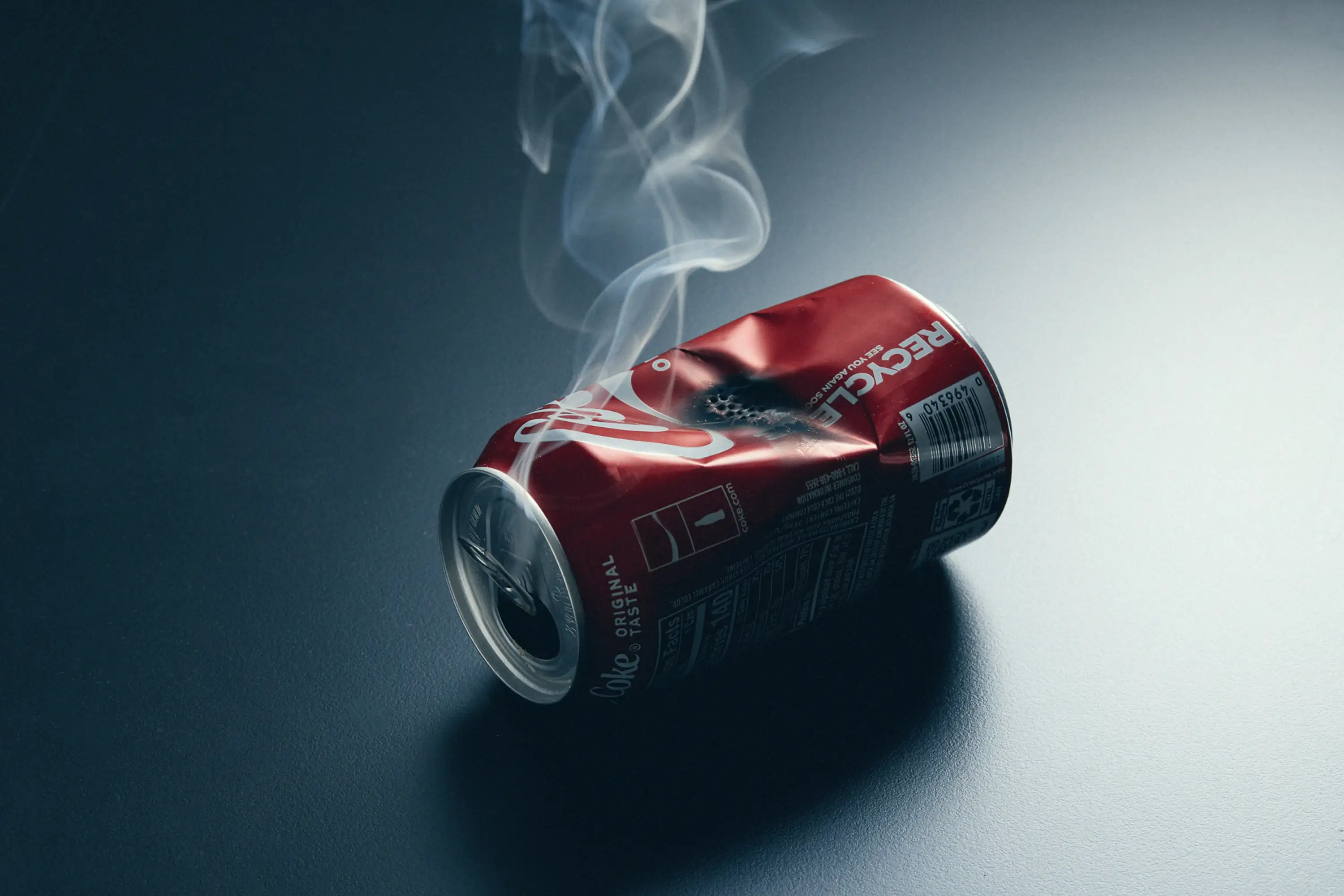 an aluminum can that has been turned into a pipe for smoking by crushing and converting the crease into a bowl for burning product