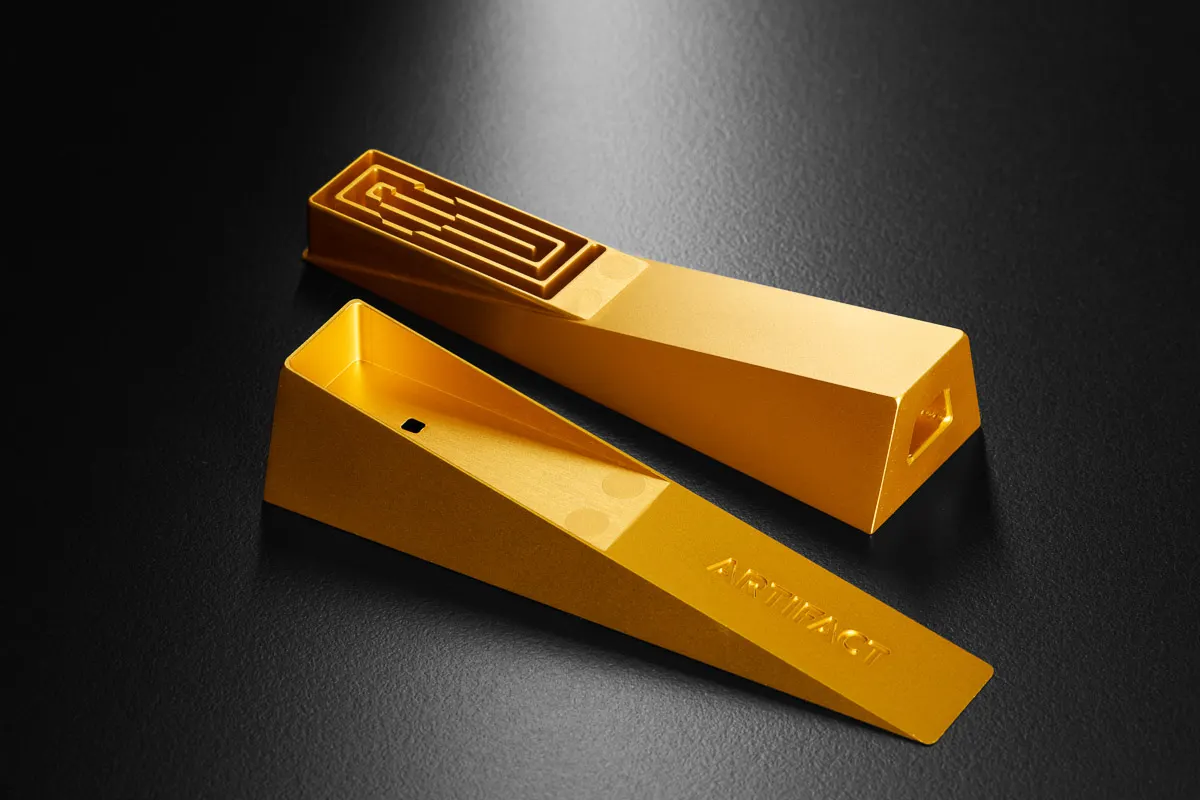 gold metal pipe photographed on a dark background