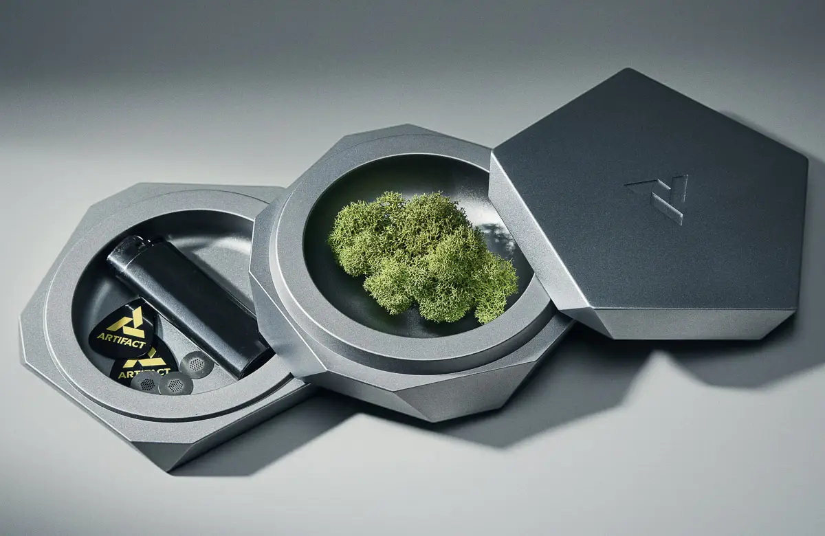 A Vesta designer ashtray in silver Mercury shown in the open position revealing two compartments for various storage conditions