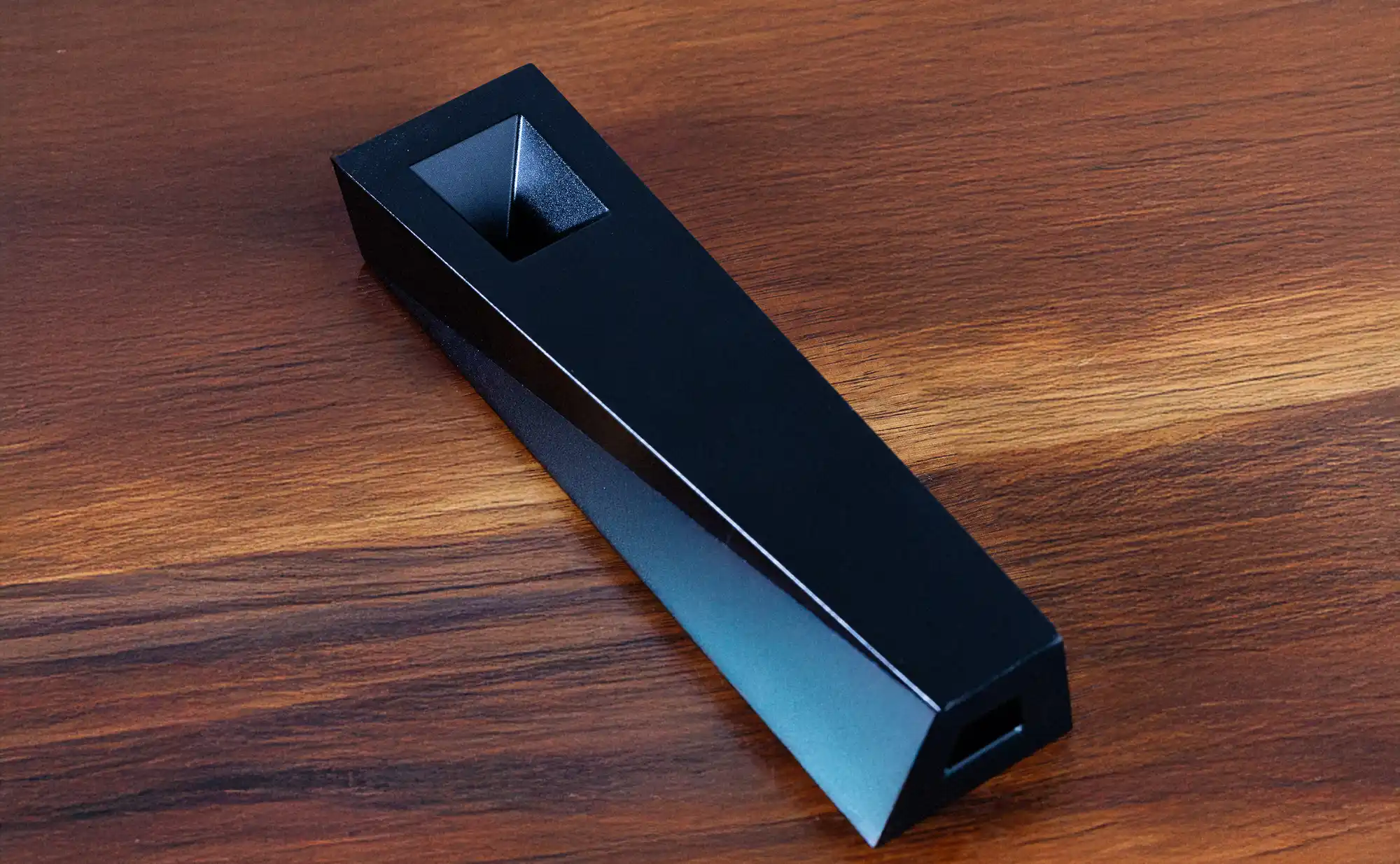 Black Tempest Abyss smoking pipe on walnut wood surface showing square bowl and tapered aluminum body