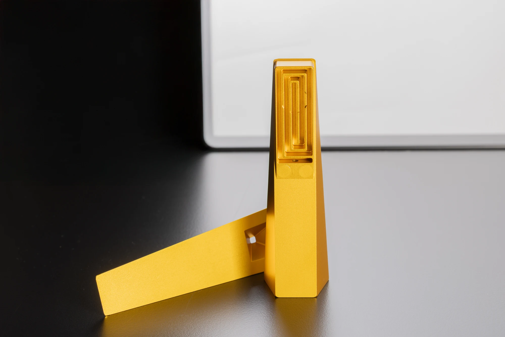 Gold Tempest Radiance smoking pipe in two magnetic halves showing internal smoke cooling labyrinth on black and white studio surface