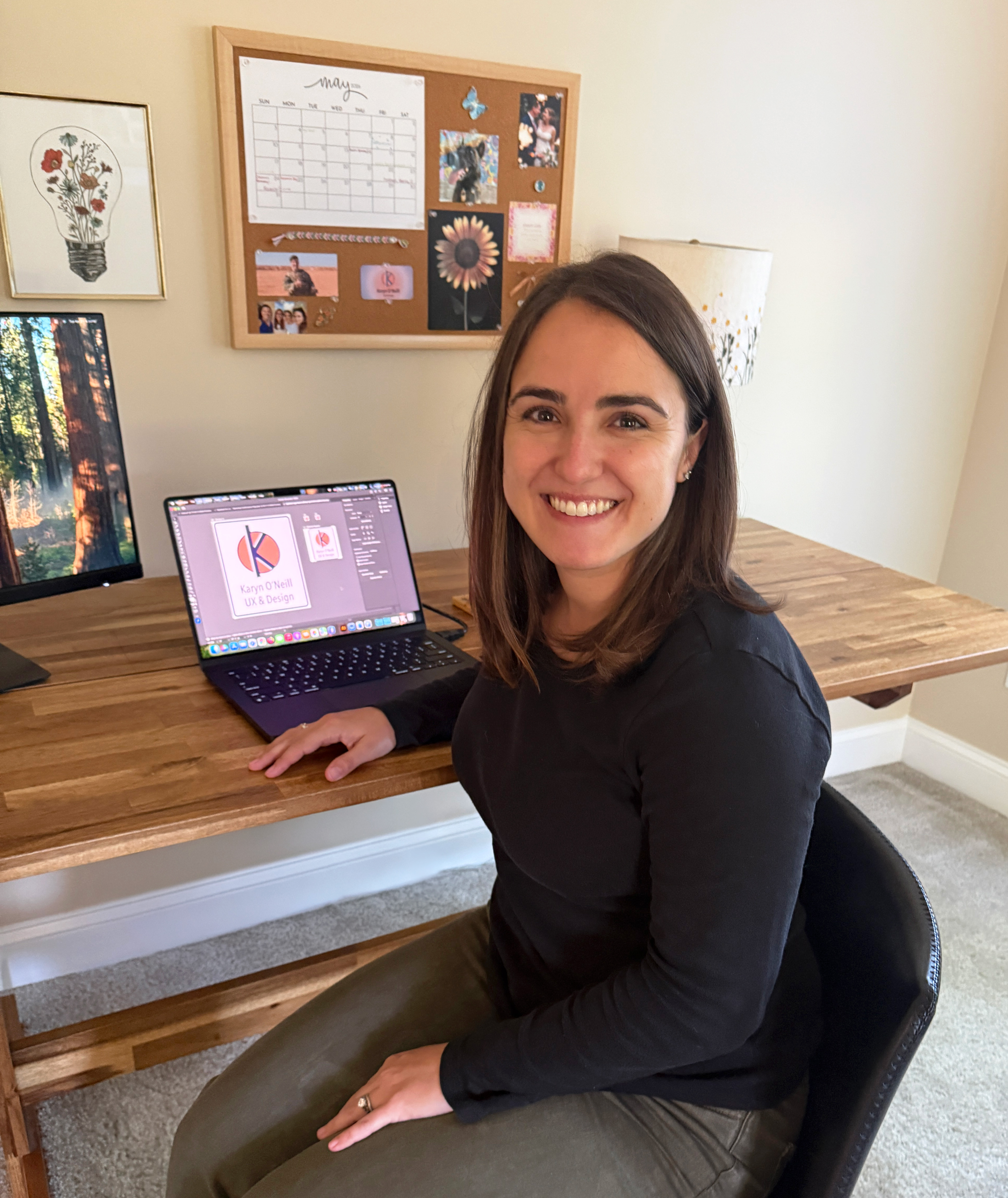 Karyn in her home office space with a desk, artwork on the walls, desk, and a chair