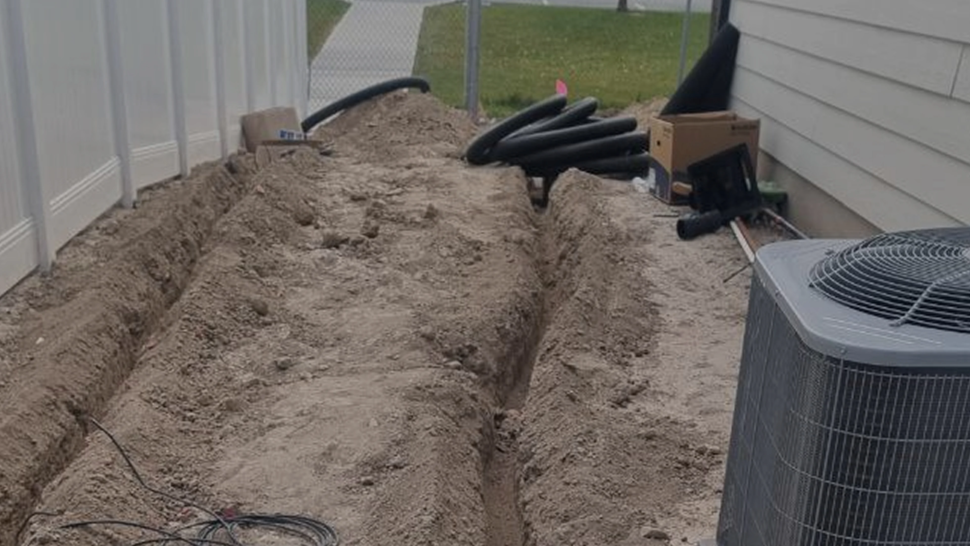 sandy trench backyard corrugated black drainage pipes