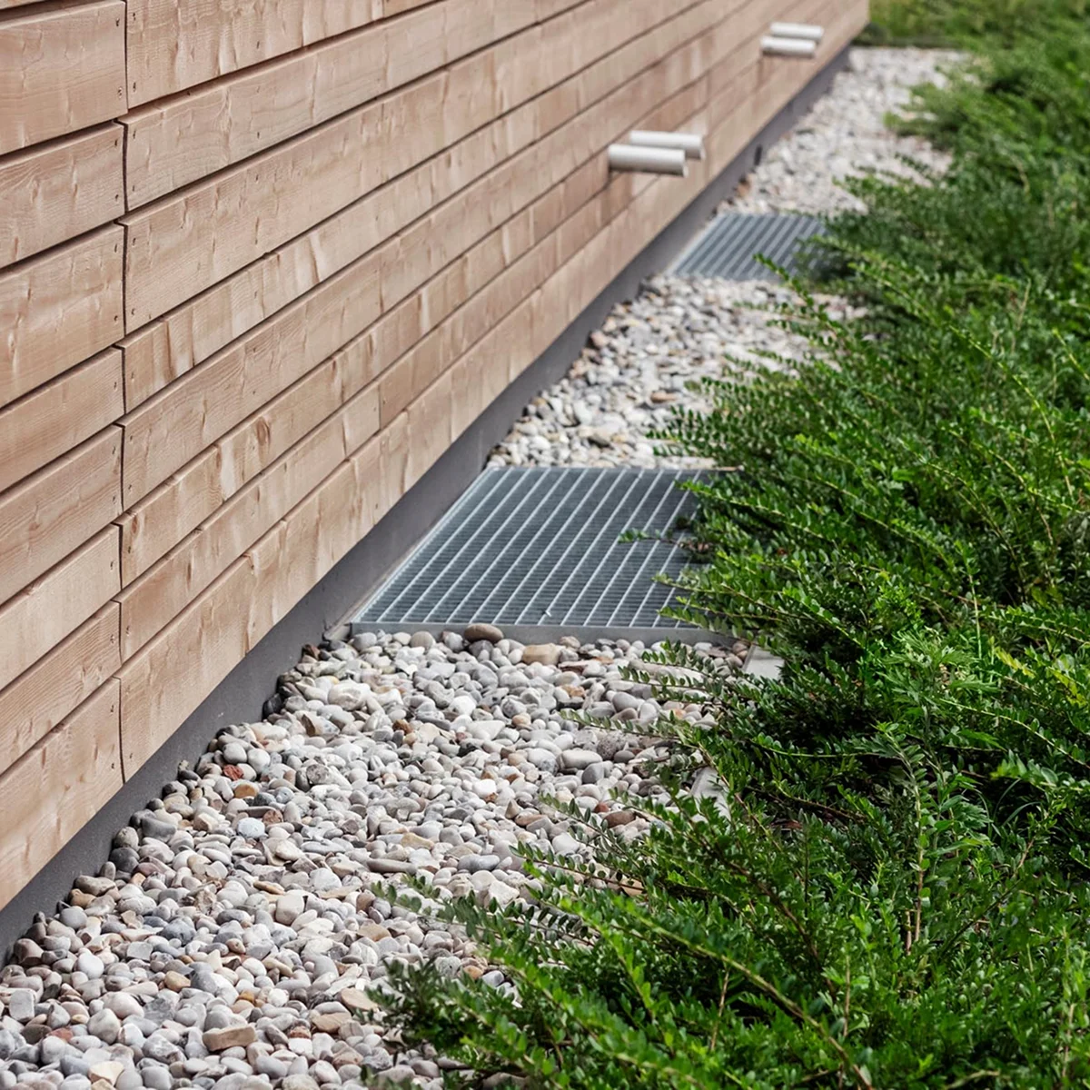 wooden house exterior gravel bed metal grates