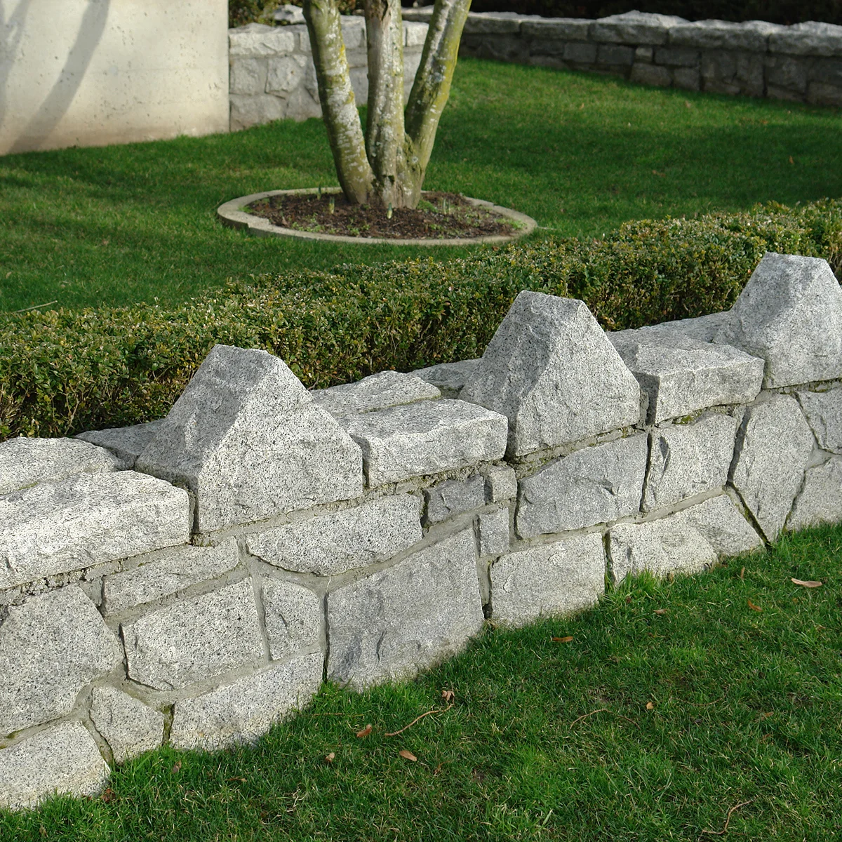 gray stone garden wall green lawn
