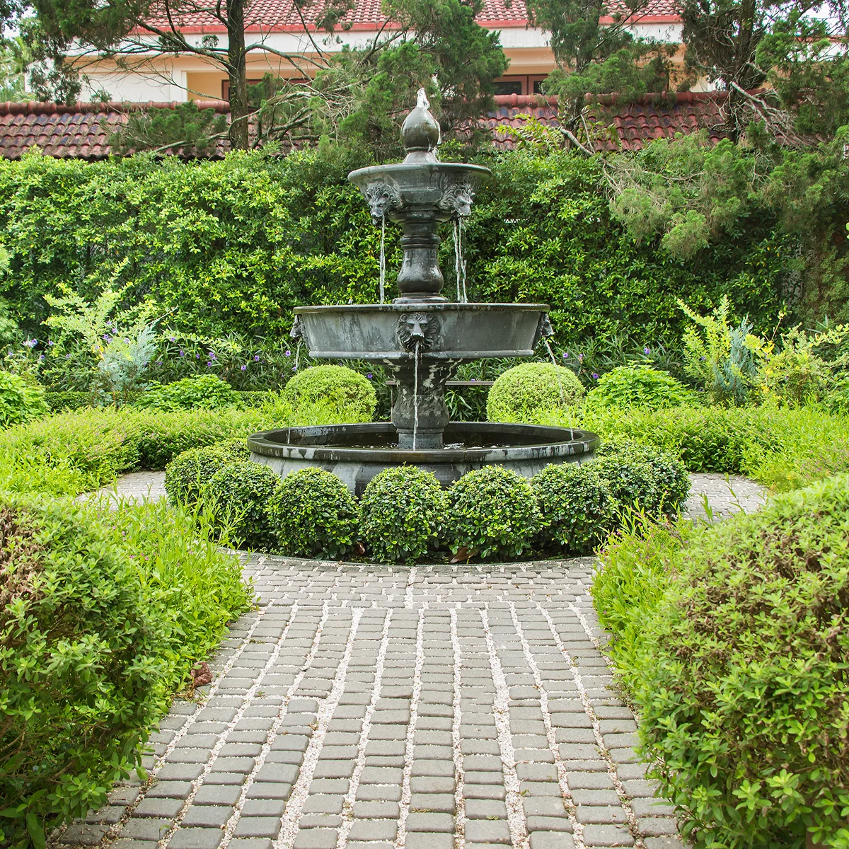 three tier gray fountain green garden brick pathway