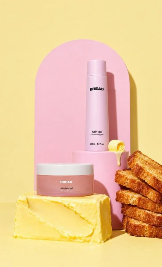slick-hold gel and hair-gel on a pink plinth with toast