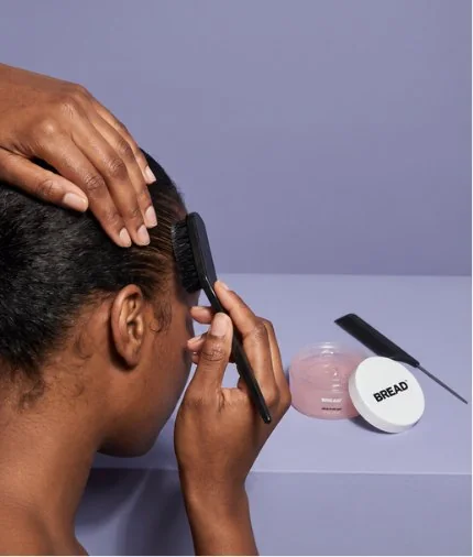 Hands laying edges with a brush