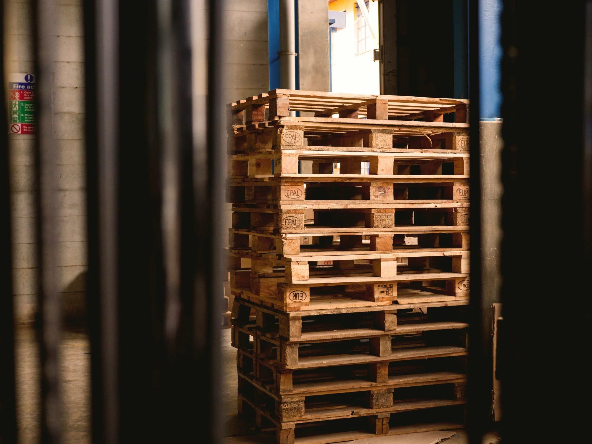 Stacked timber pallets in a warehouse