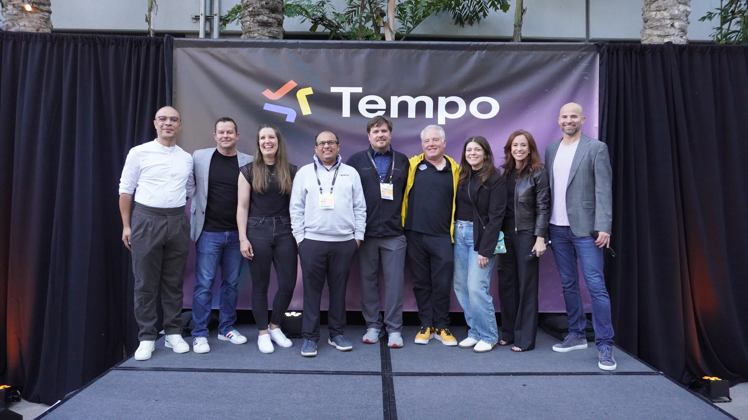 group of Tempo team members and tempo Partner members posing for a photo on stage at the Tempo Partner Awards event