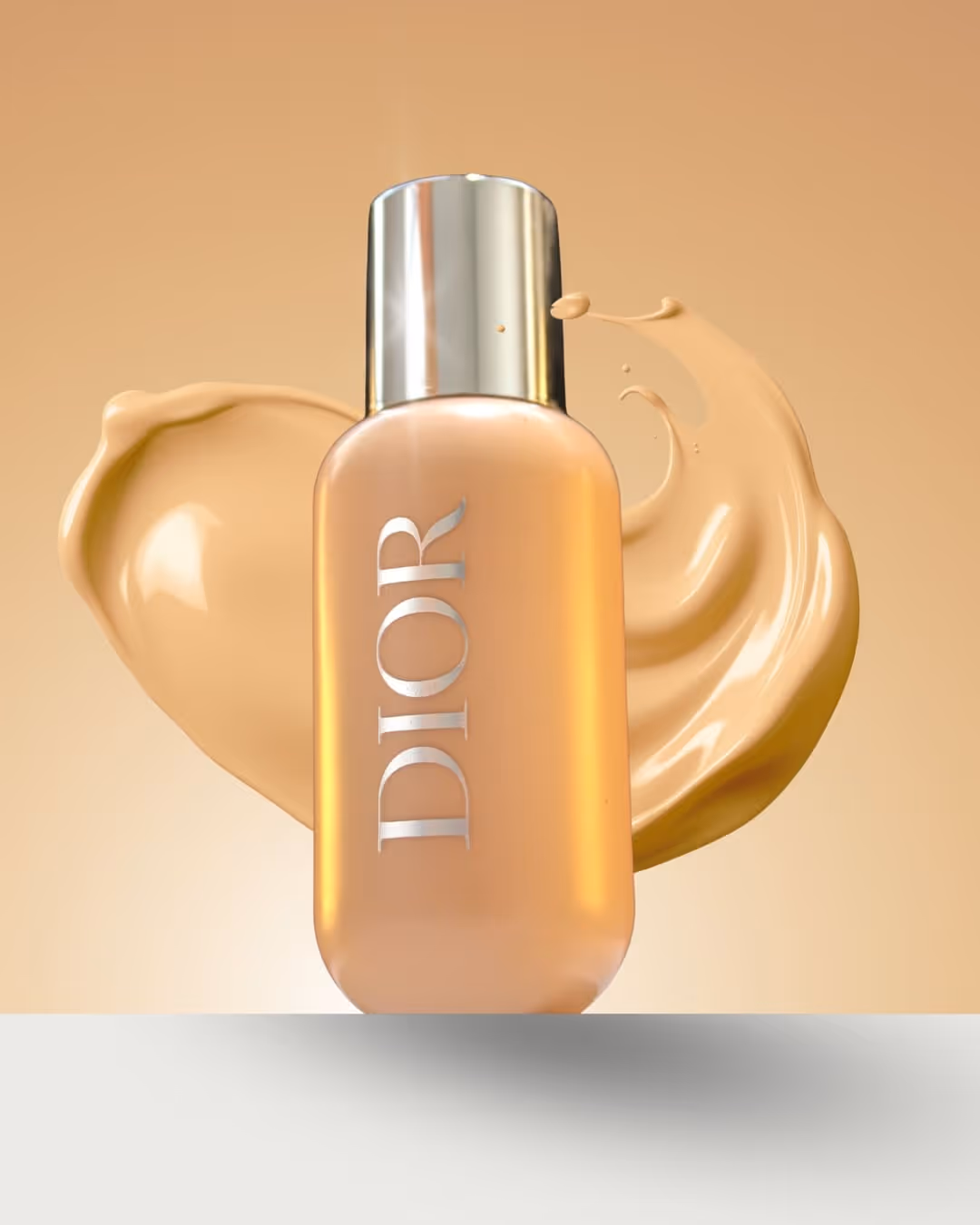 Bottle of Dior foundation with beige liquid foundation splashes in the background.
