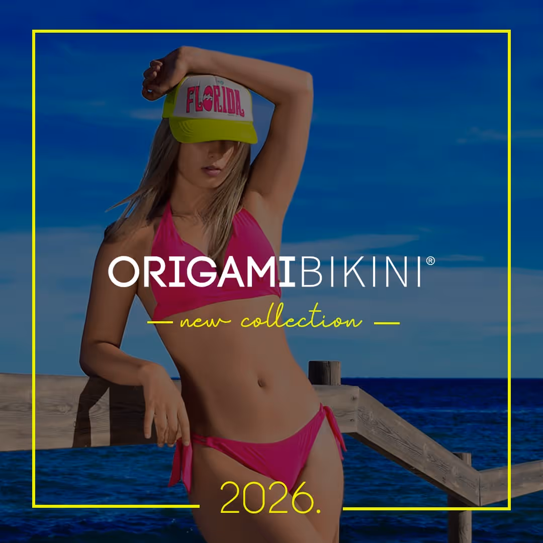 Woman in a pink bikini and Florida cap posing by a wooden railing with ocean background, promoting Origami Bikini new collection 2026.