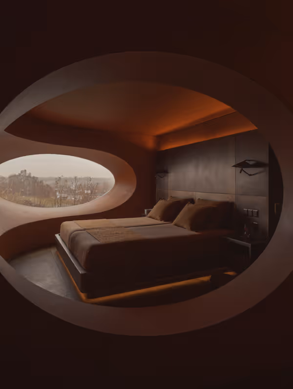 Modern bedroom with a large oval window offering a view of trees and hills, featuring a platform bed with brown bedding and ambient ceiling lighting.