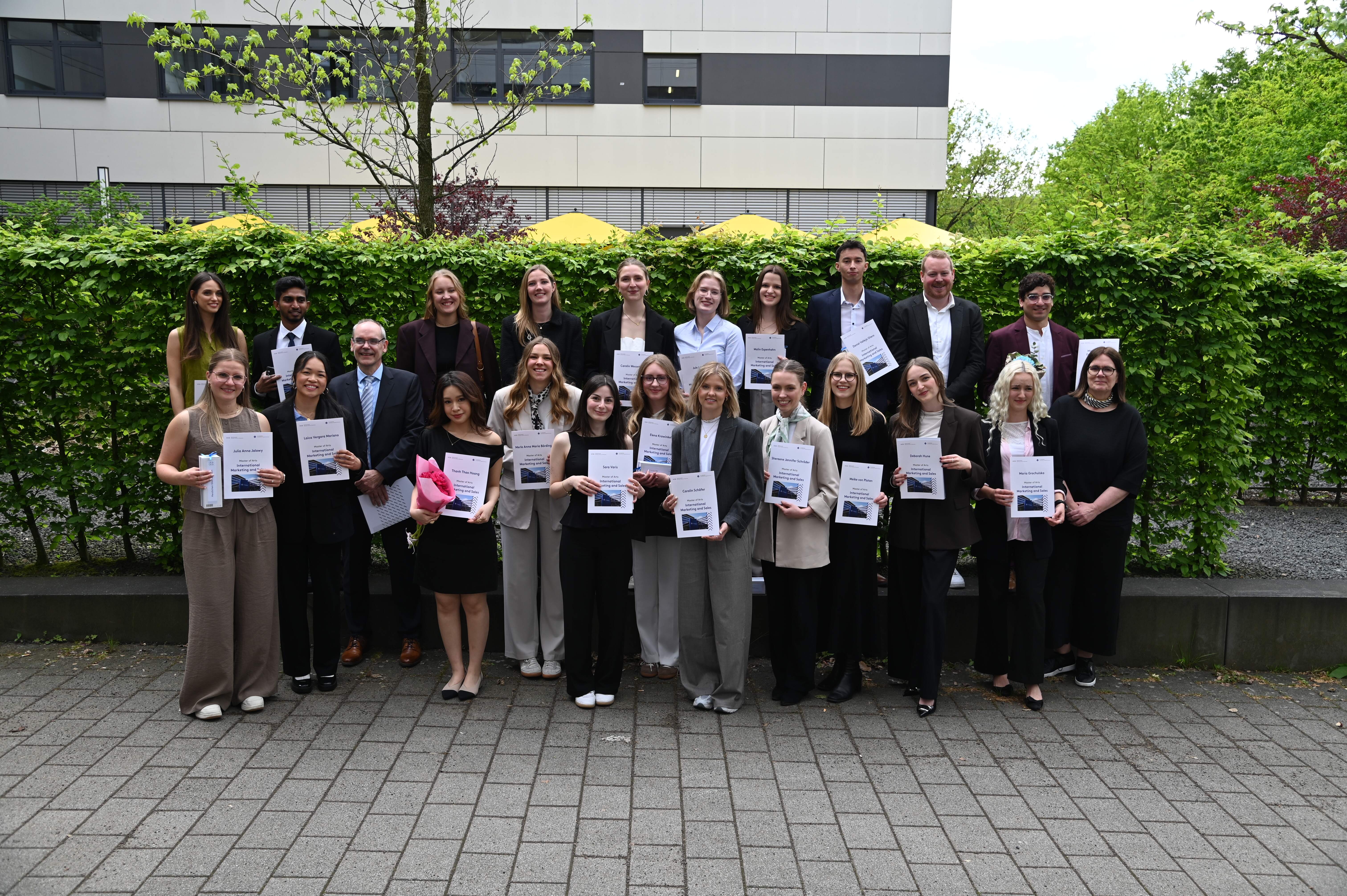 Group photo of IMS graduates celebrating the successful completion of their Master's degree at FH Münster.