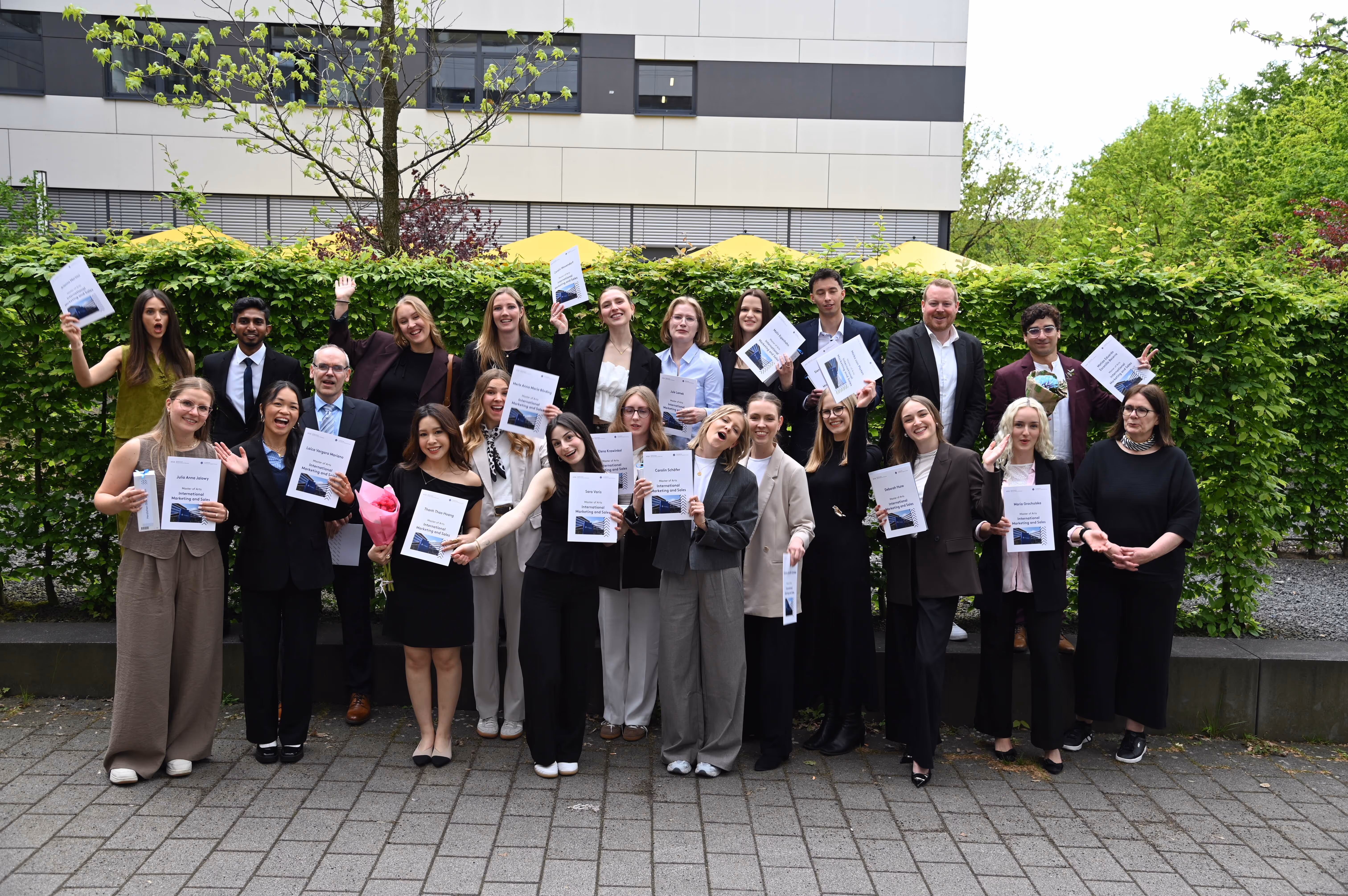 Group photo of IMS graduates celebrating the successful completion of their Master's degree at FH Münster.