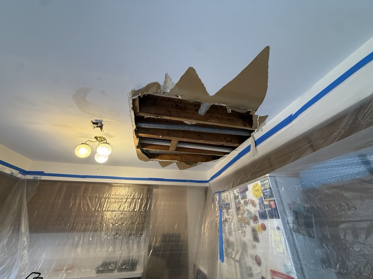 Kitchen ceiling with visible water damage stains before drywall repair in Naperville, IL