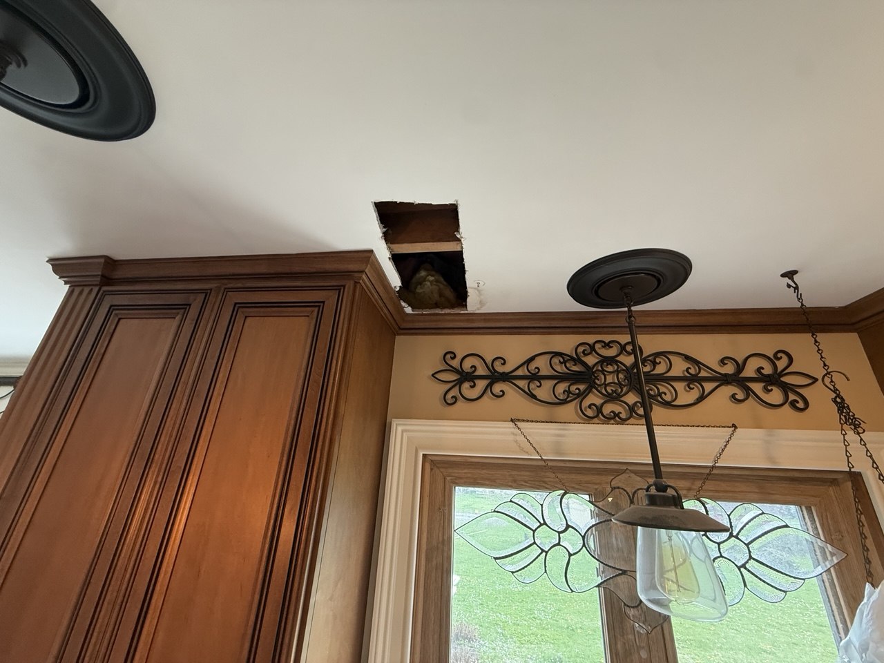 Before ceiling drywall repair by EasyPatch in Naperville, IL showing an open damaged ceiling area near kitchen cabinets.