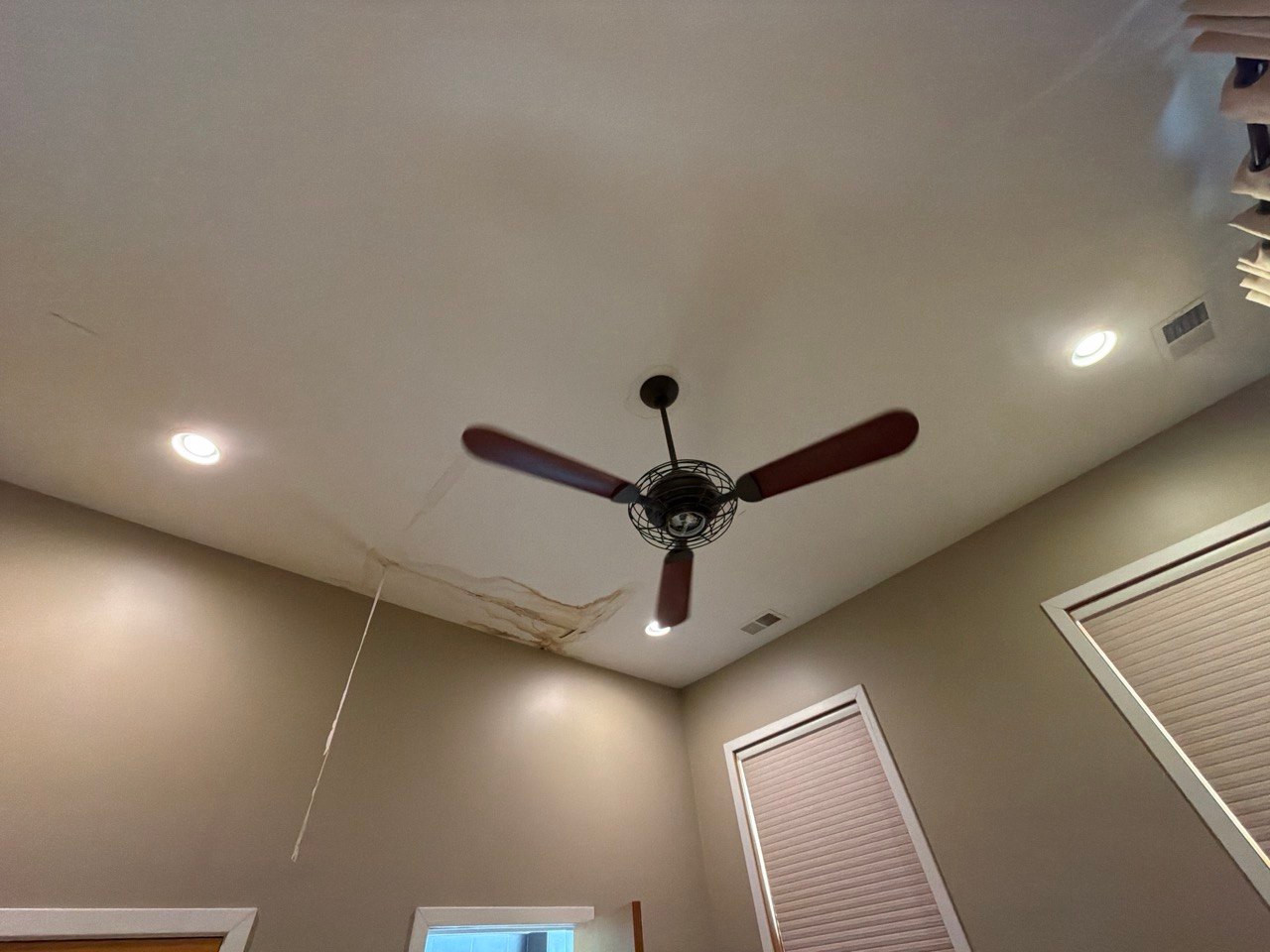 Water-stained and peeling ceiling in a Wheaton home before repair after a roof leak