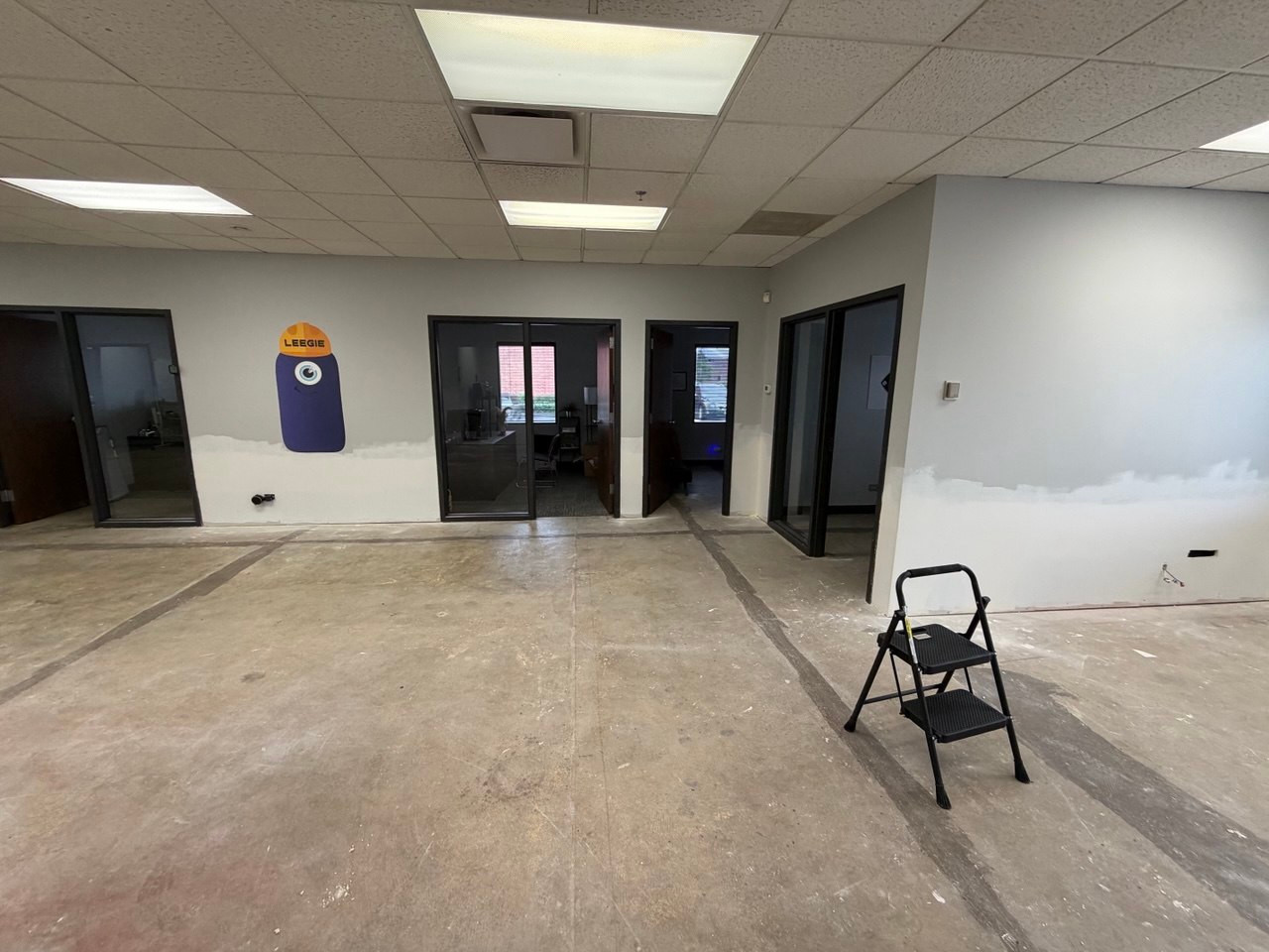 Repaired lower wall sections at the primer stage in a Willowbrook commercial space