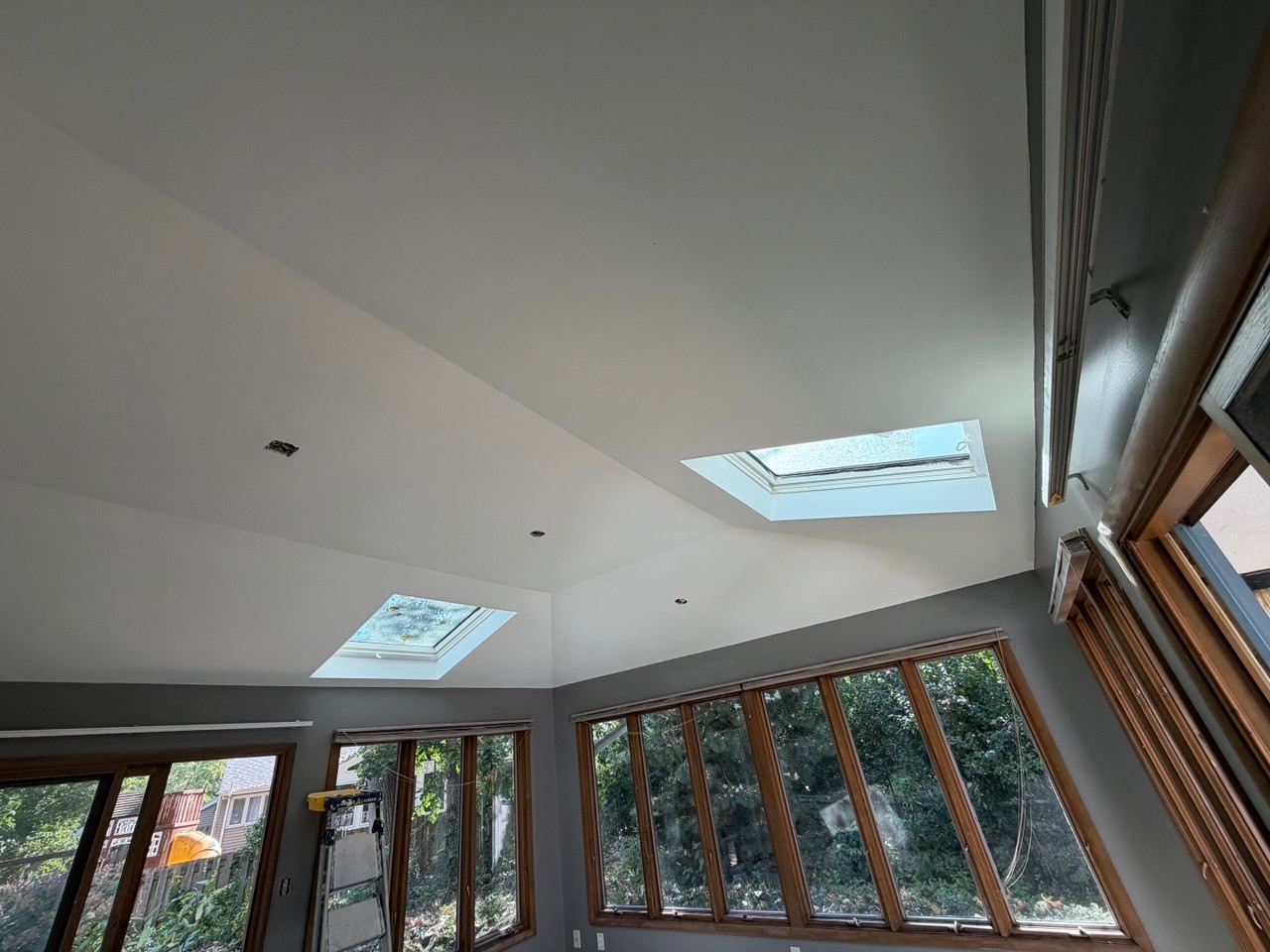 New ceiling around two skylights and painted walls in Batavia, with light fixtures not yet installed